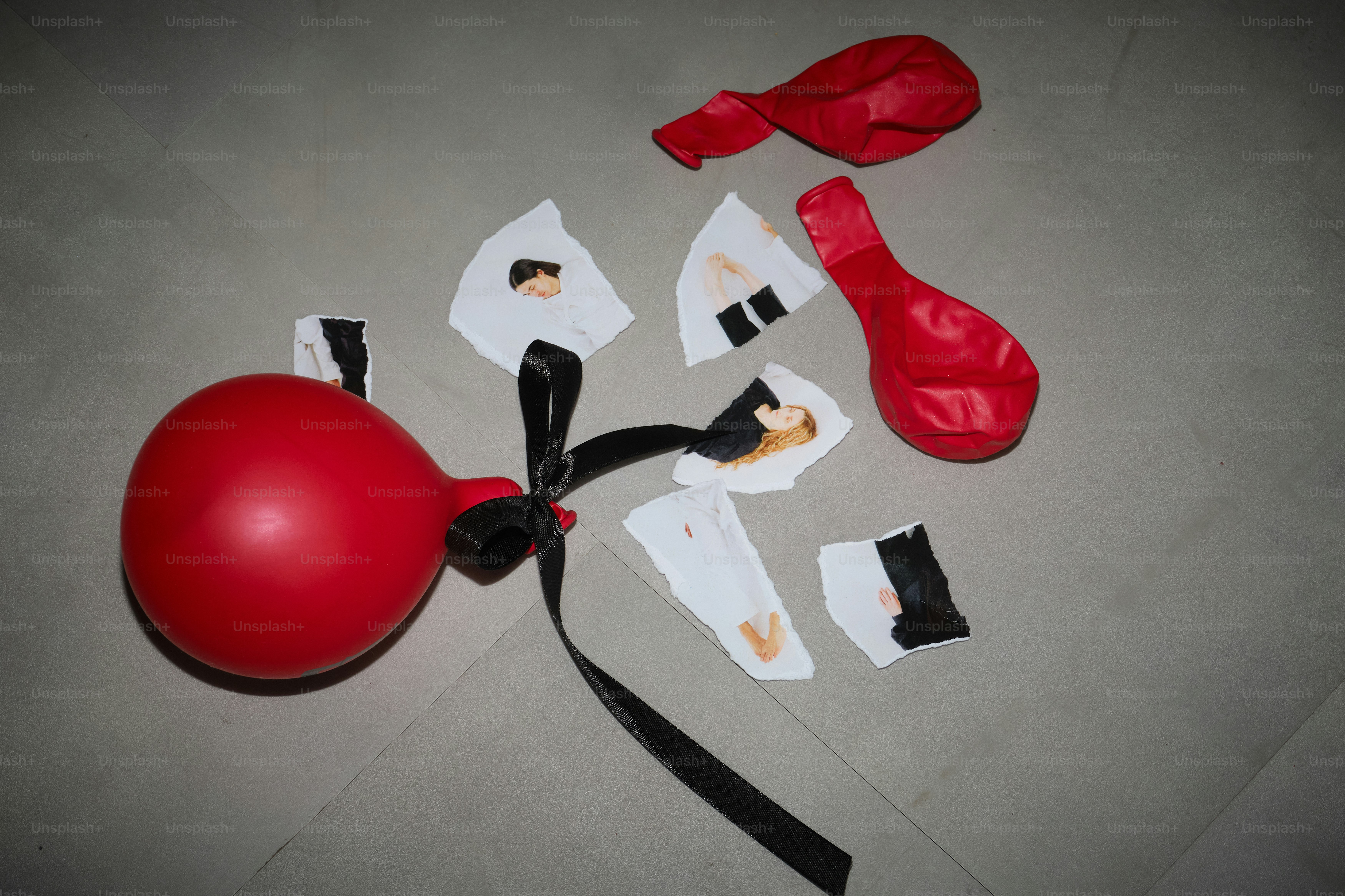A red balloon and its torn pieces