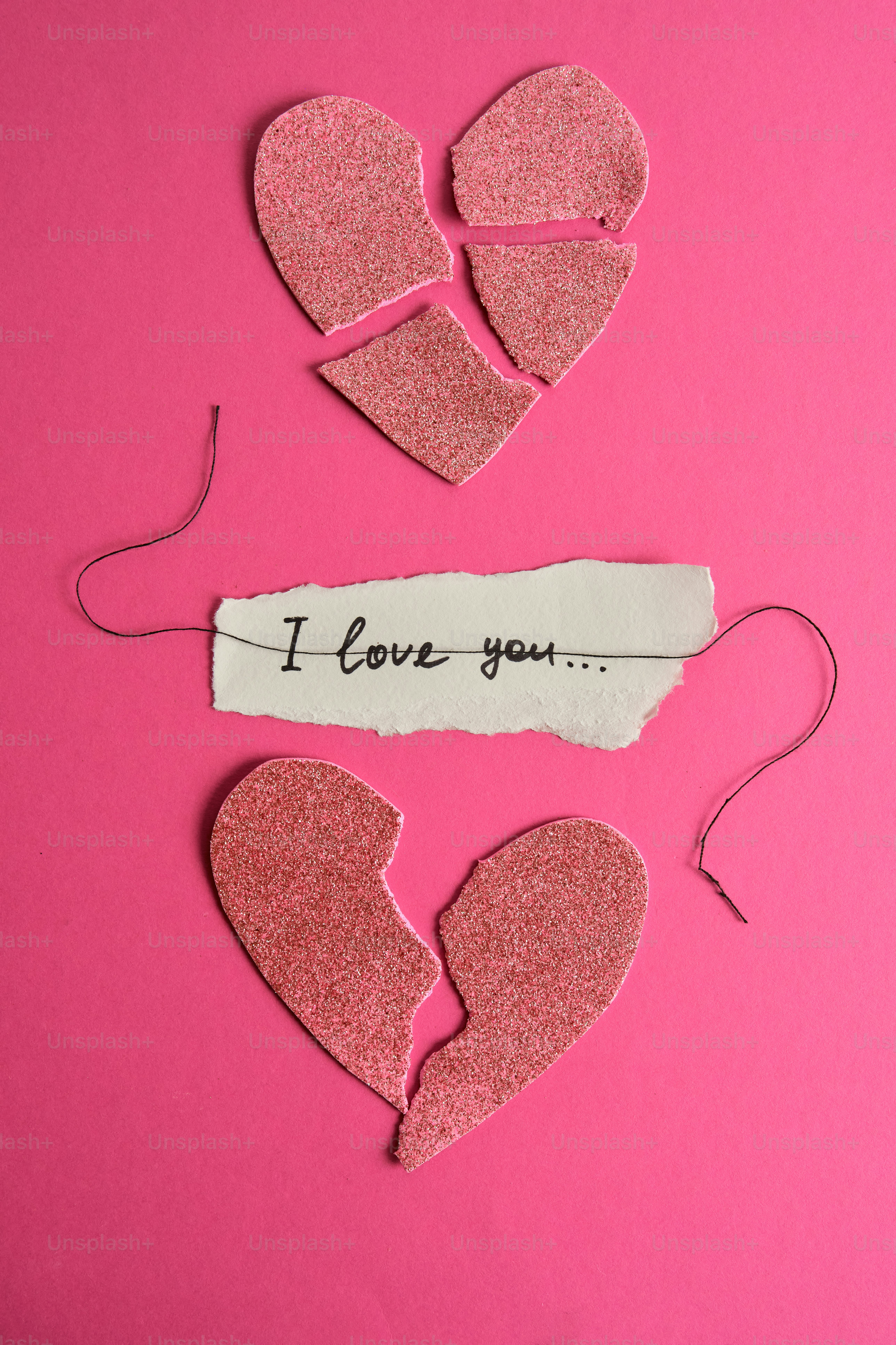 Broken heart with message on pink background