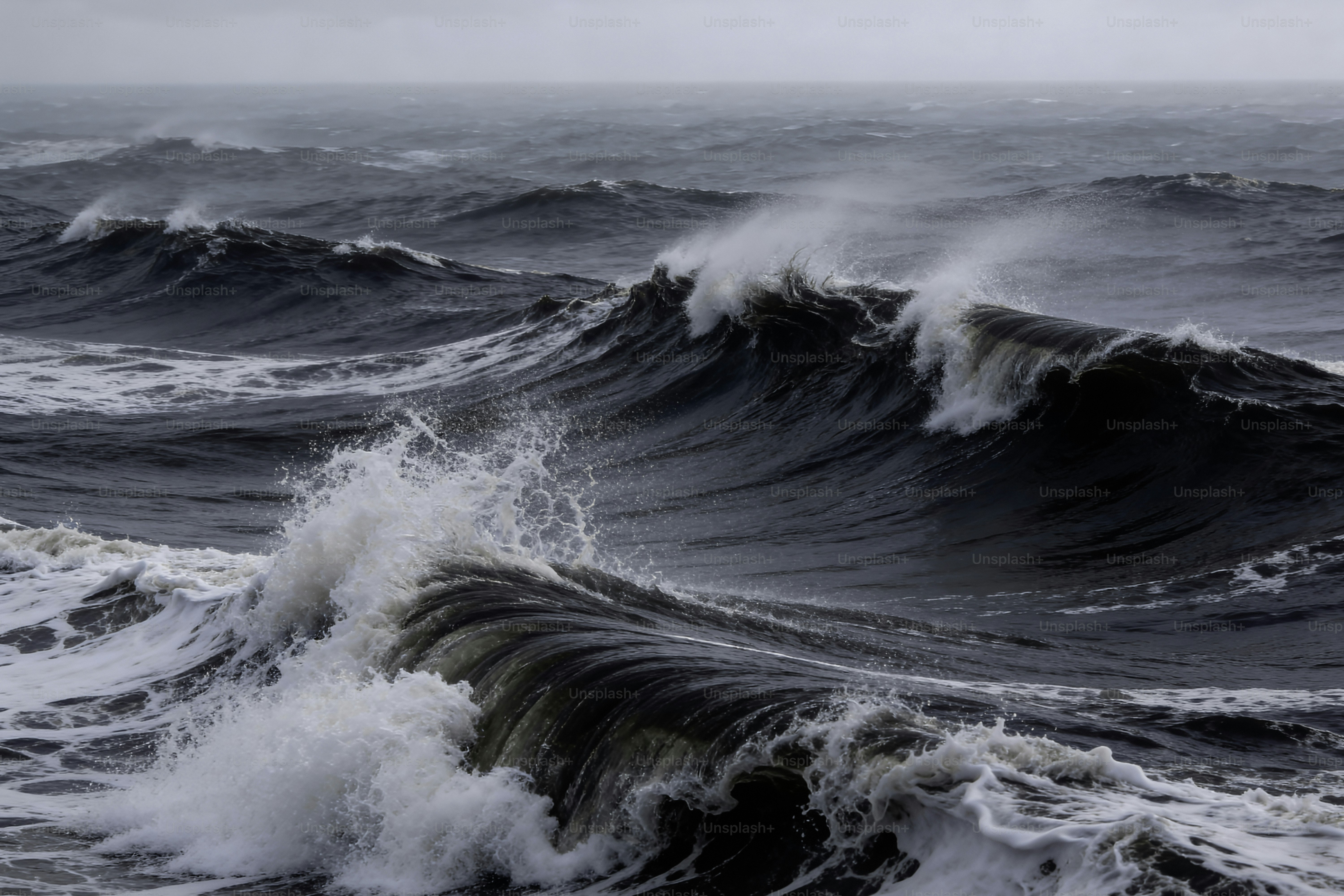 Crashing ocean waves under a stormy sky