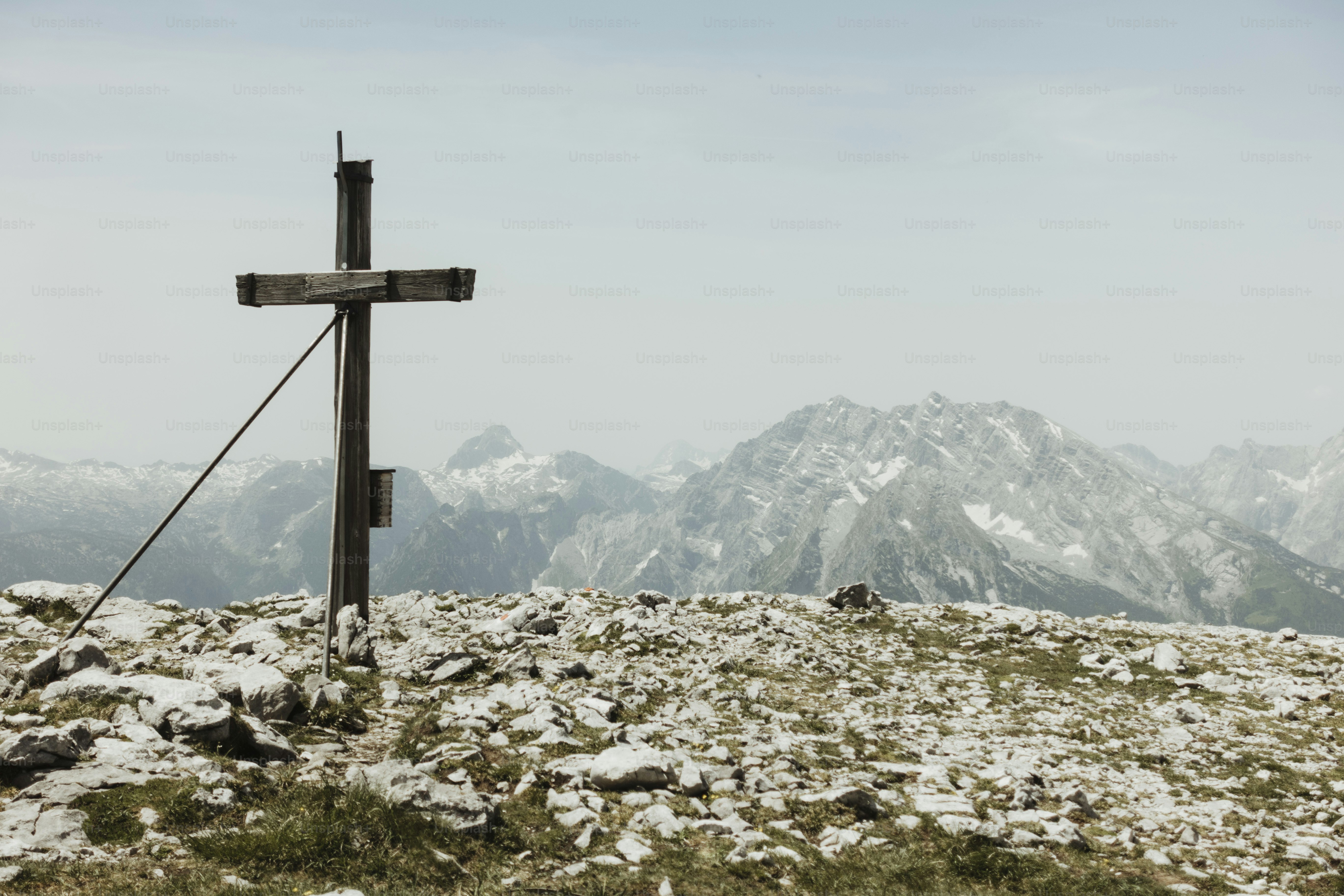 Wooden cross on a rocky mountain summit