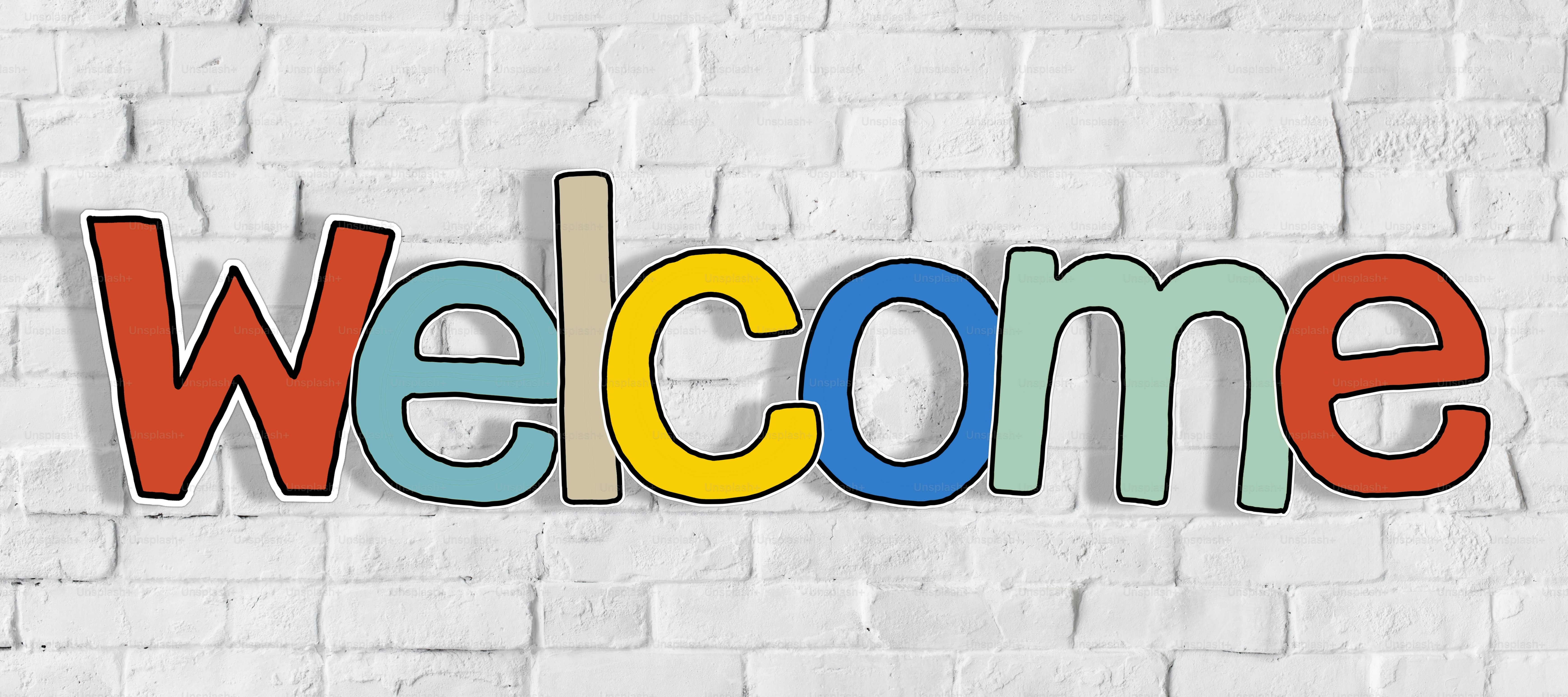 Welcome Word and Brick Wall in Background