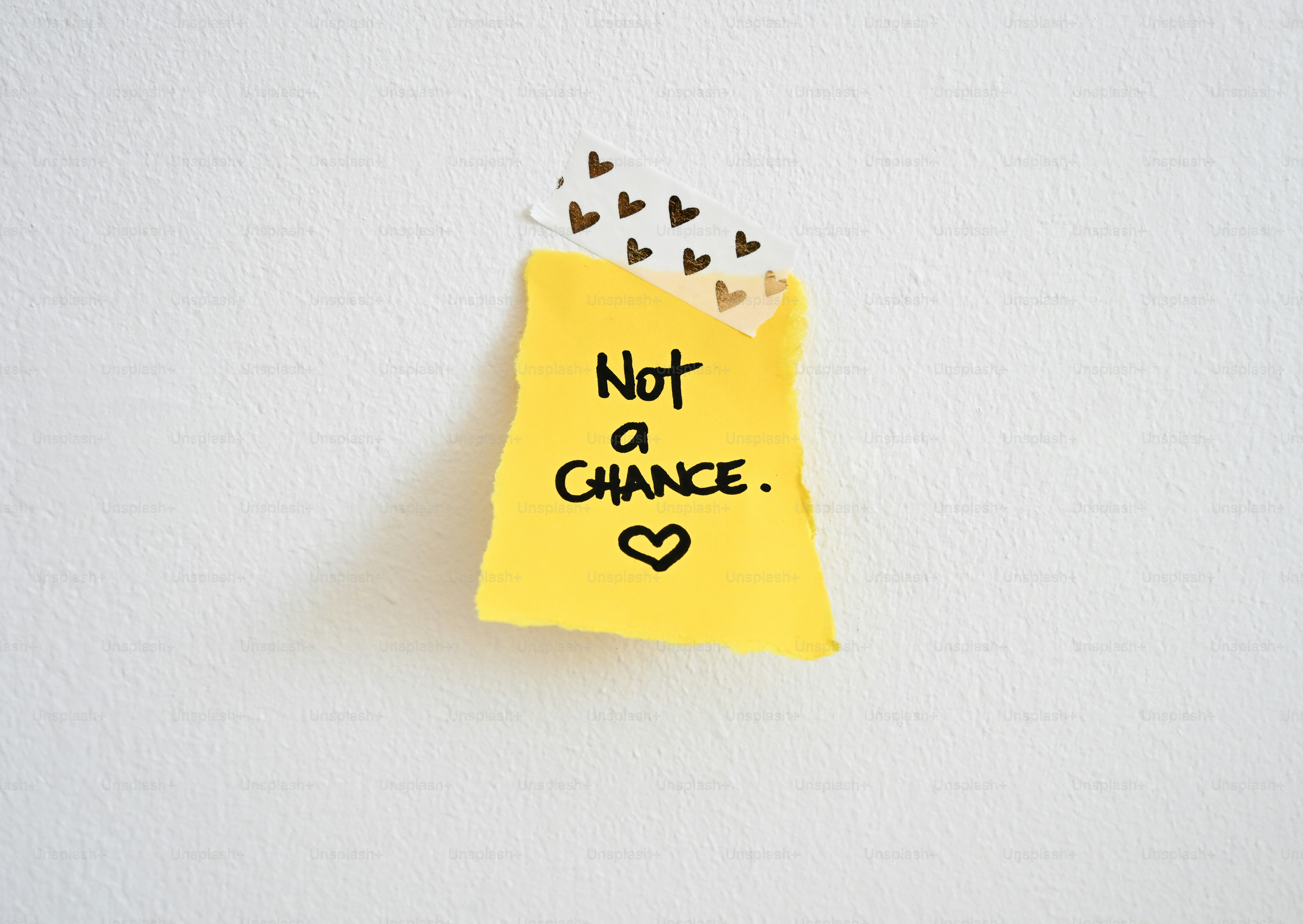 Yellow sticky note with "not a chance." and heart.