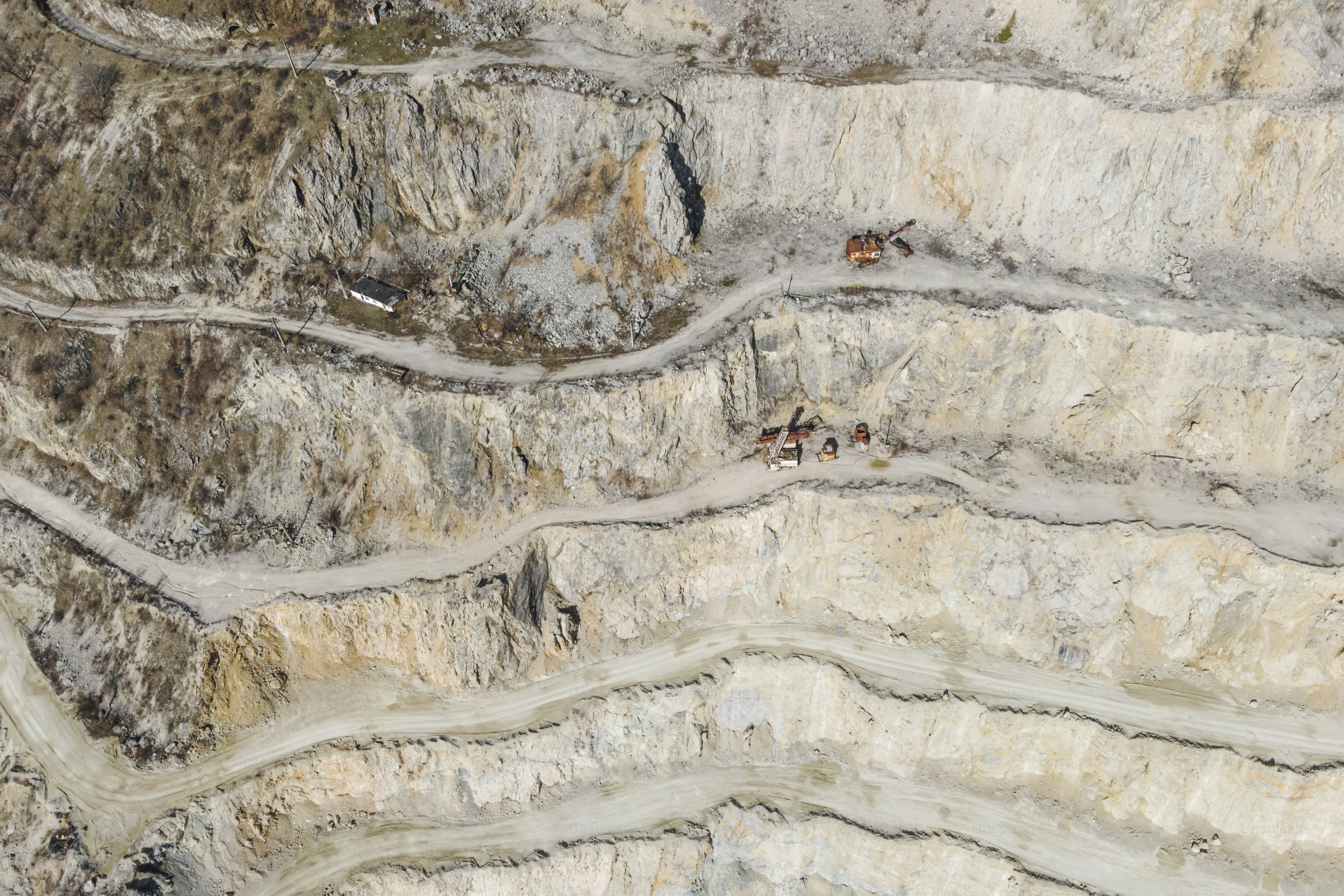 Aerial view of a quarry with layered rock formations. photo – Industry ...