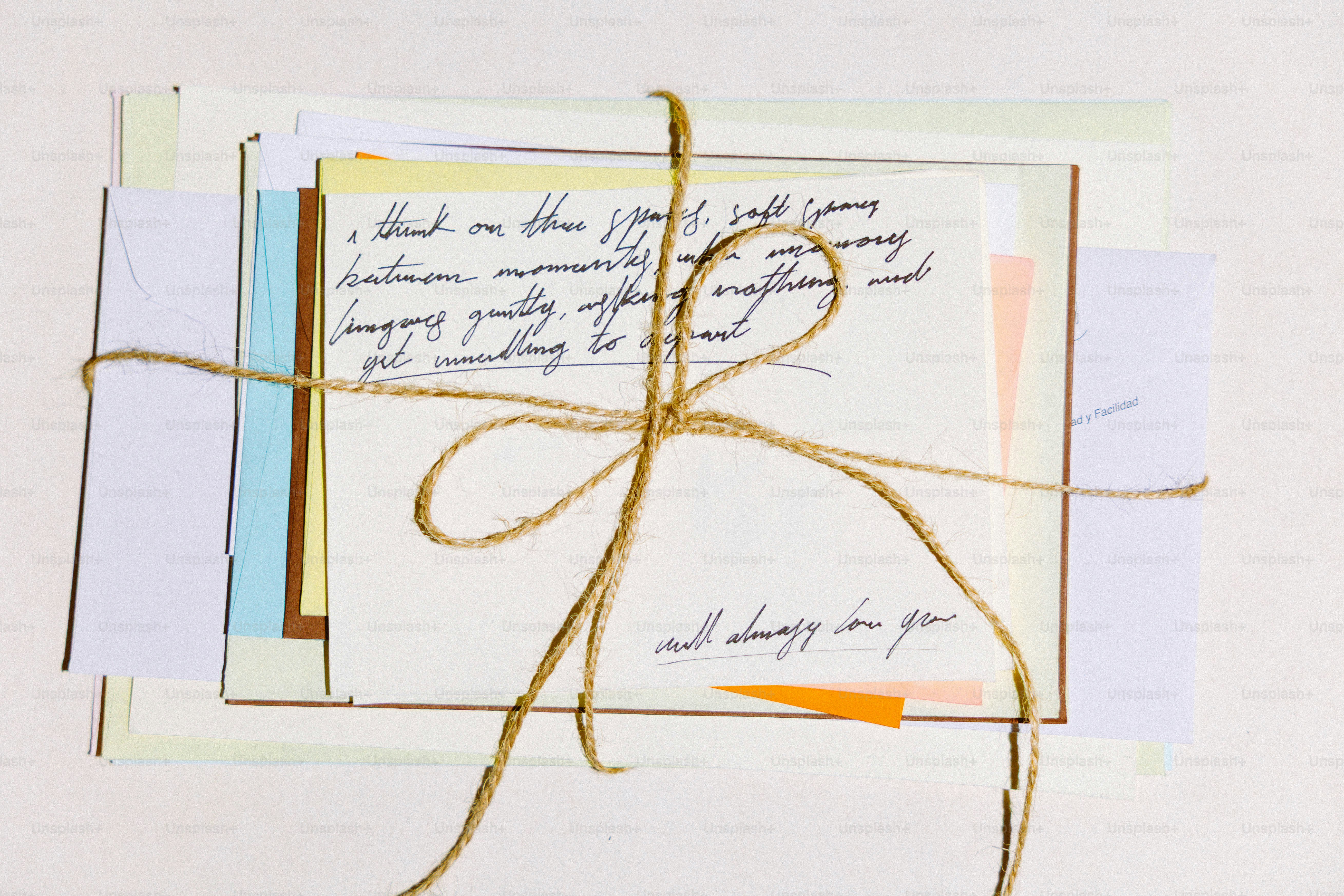 Stack of letters tied with twine on white background