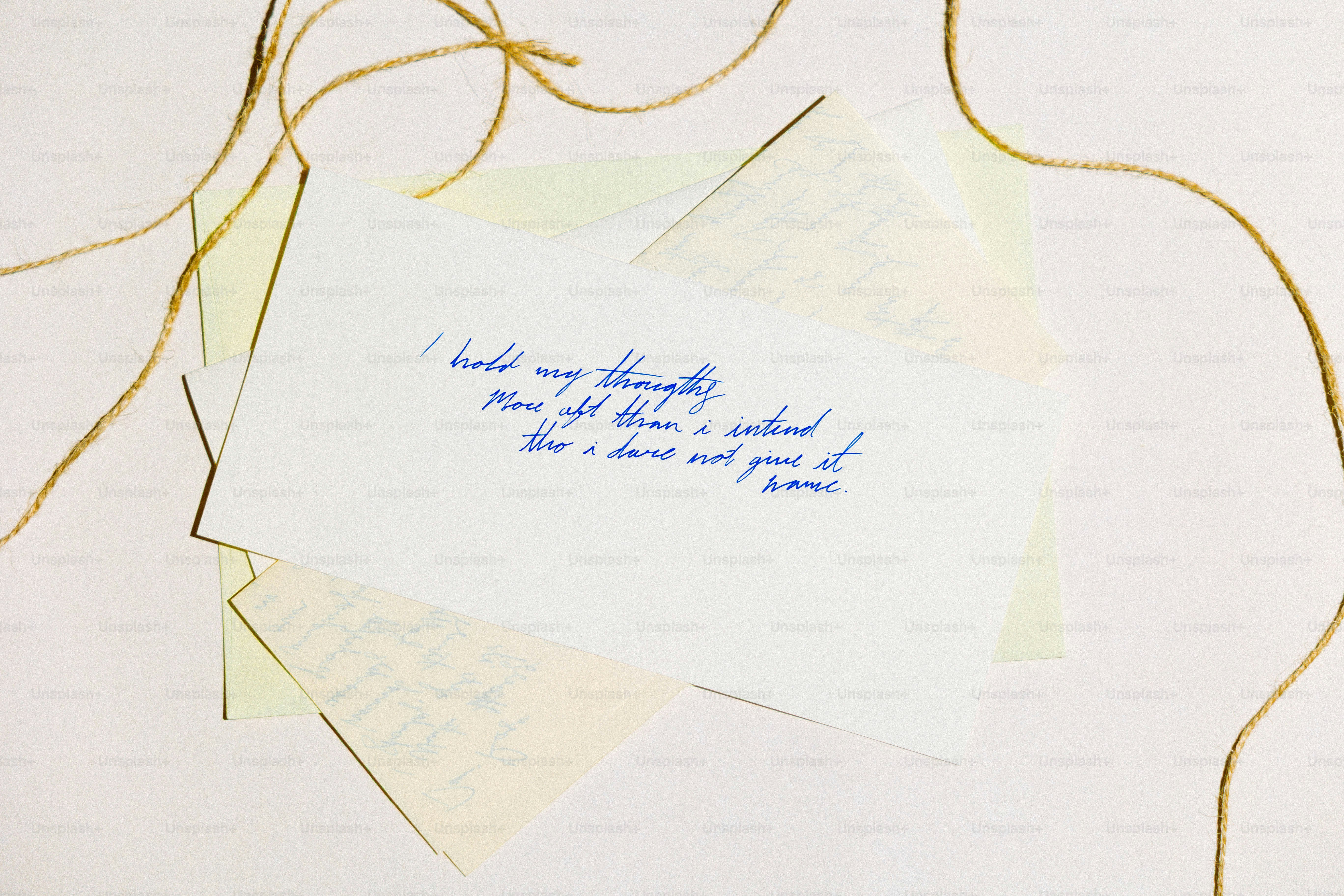 White card with handwritten blue ink text and string.