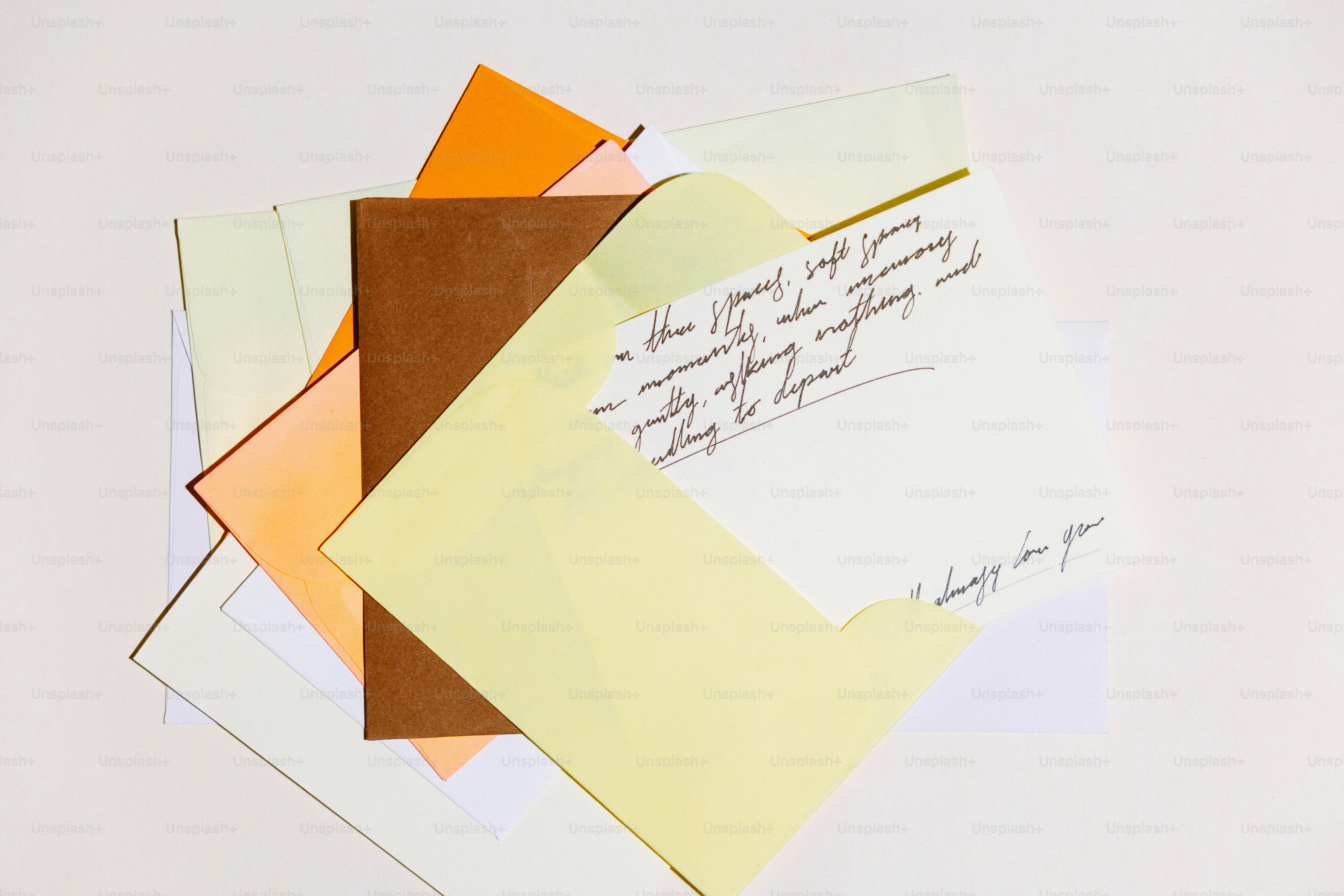Several envelopes and papers layered on a white surface.