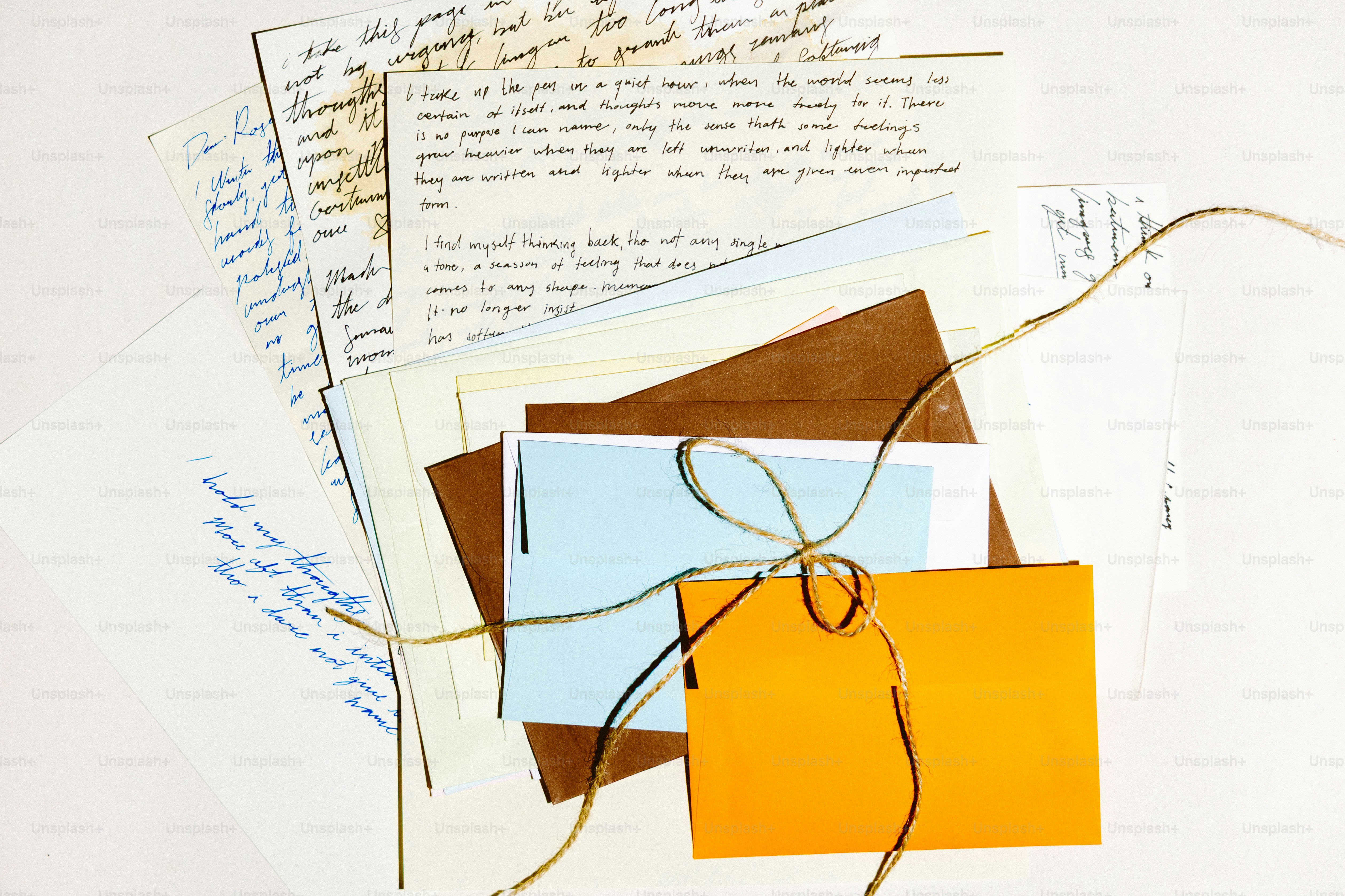 Handwritten letters tied with twine and colorful envelopes.