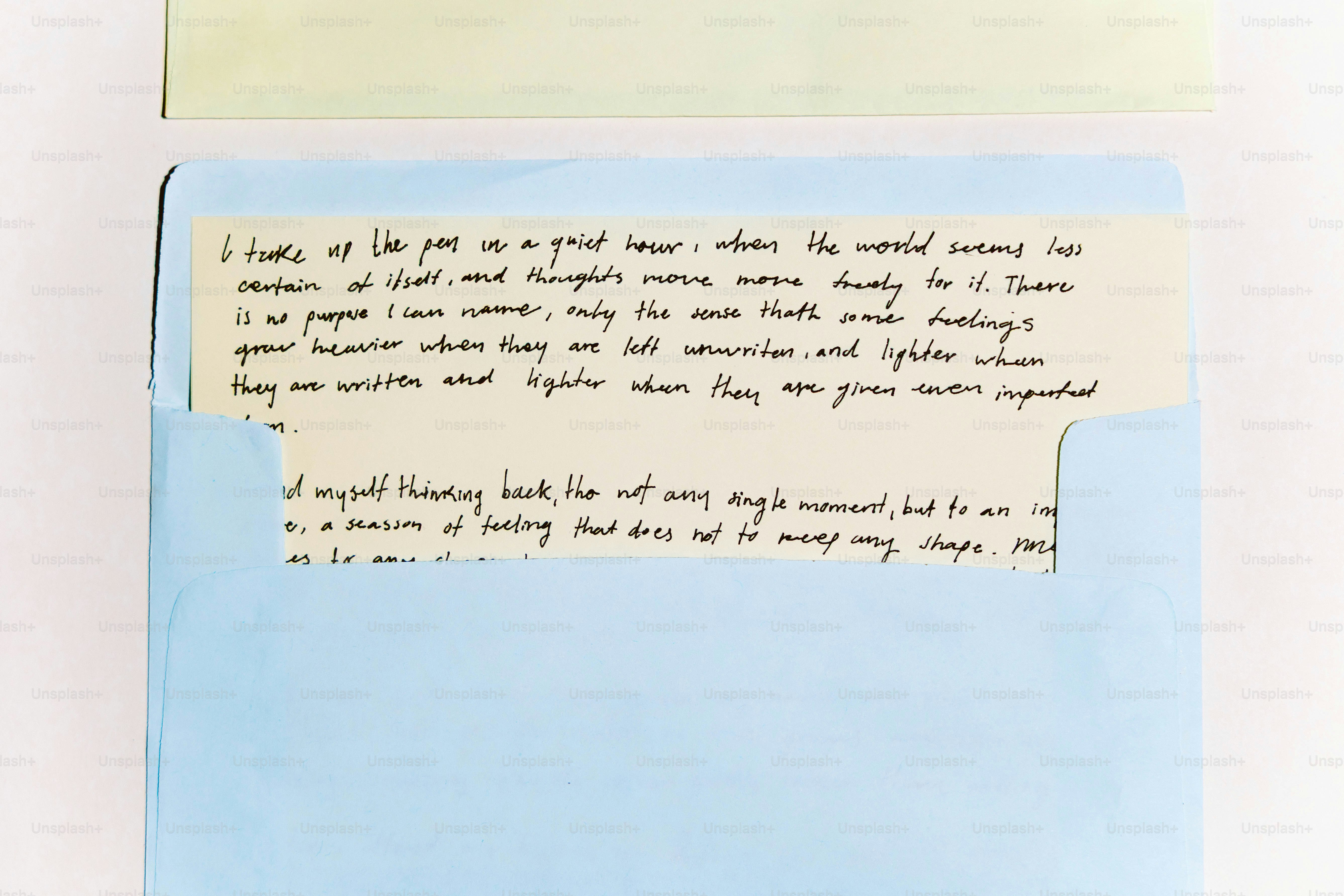 Handwritten letter peeking out of a blue envelope