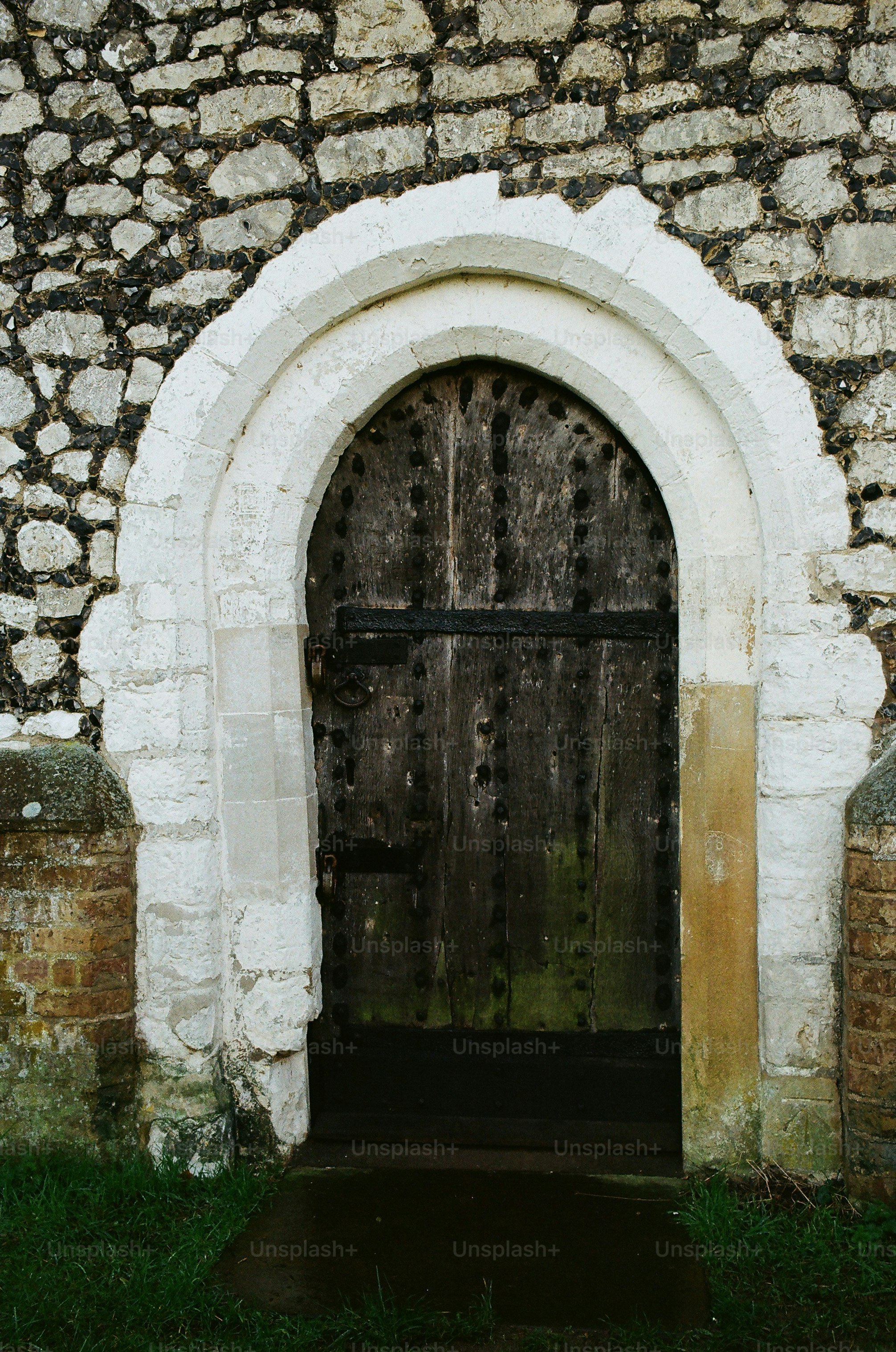 An old wooden door set in a stone wall.