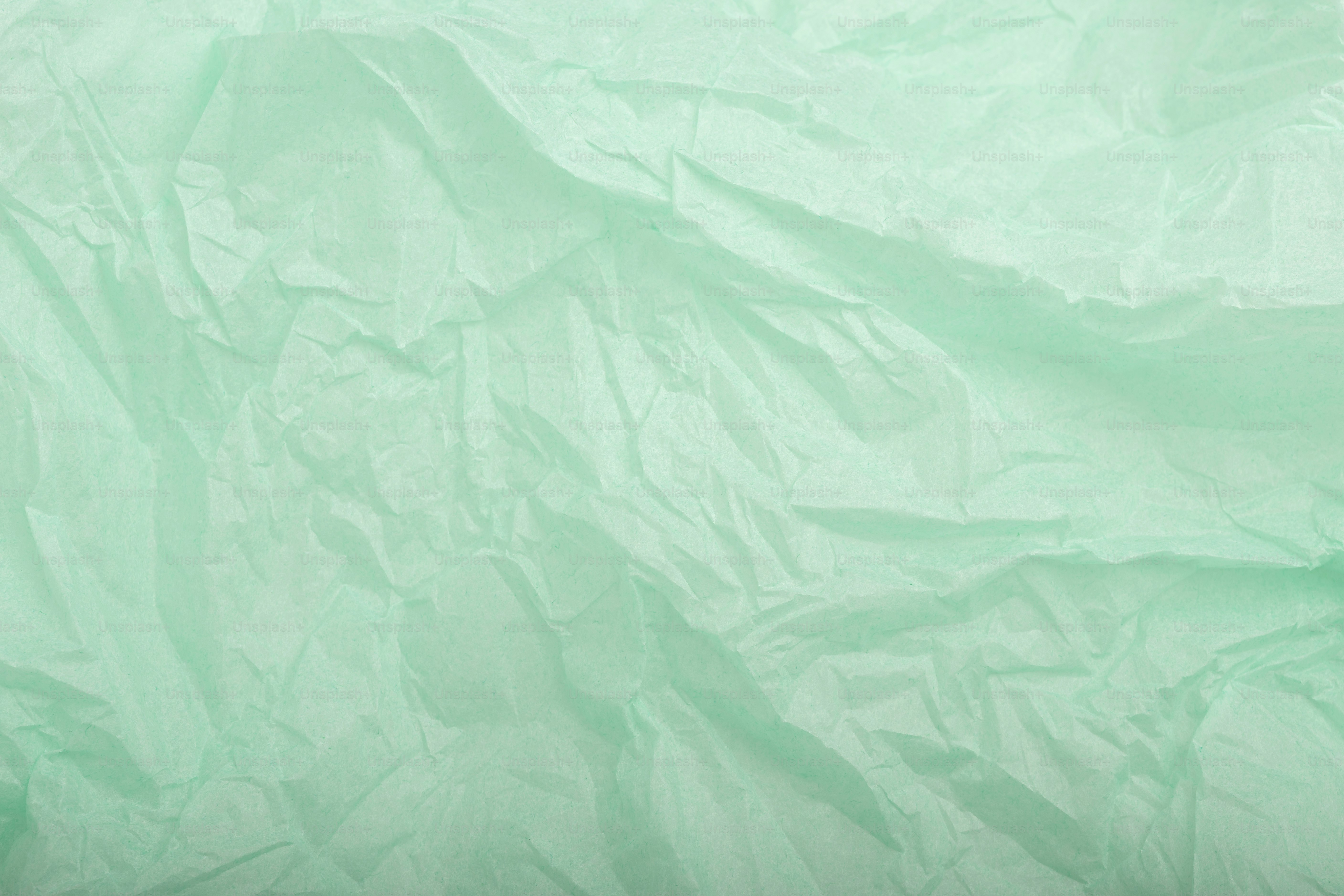A pale green crumpled textured background