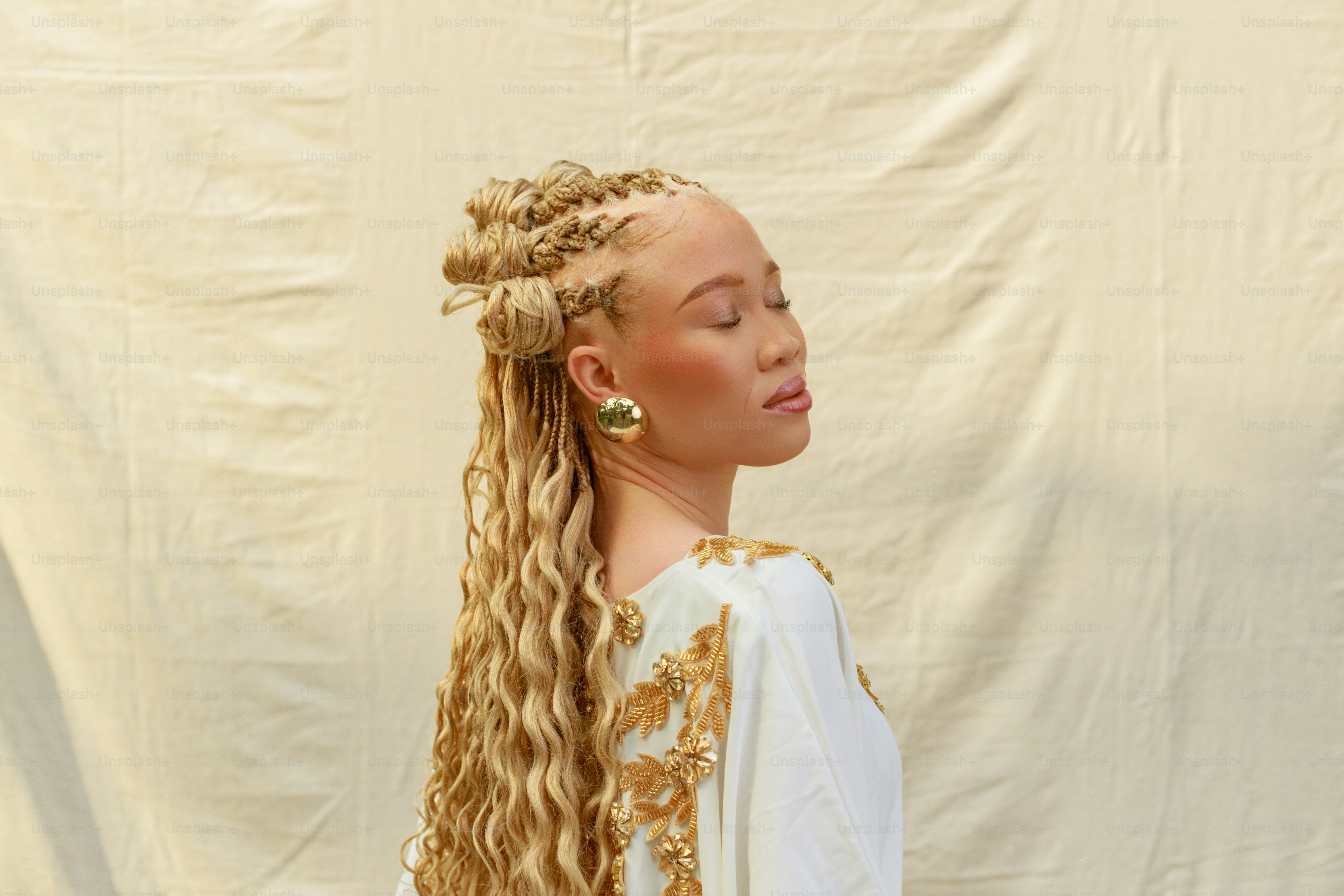 Woman with blonde braids and golden earrings
