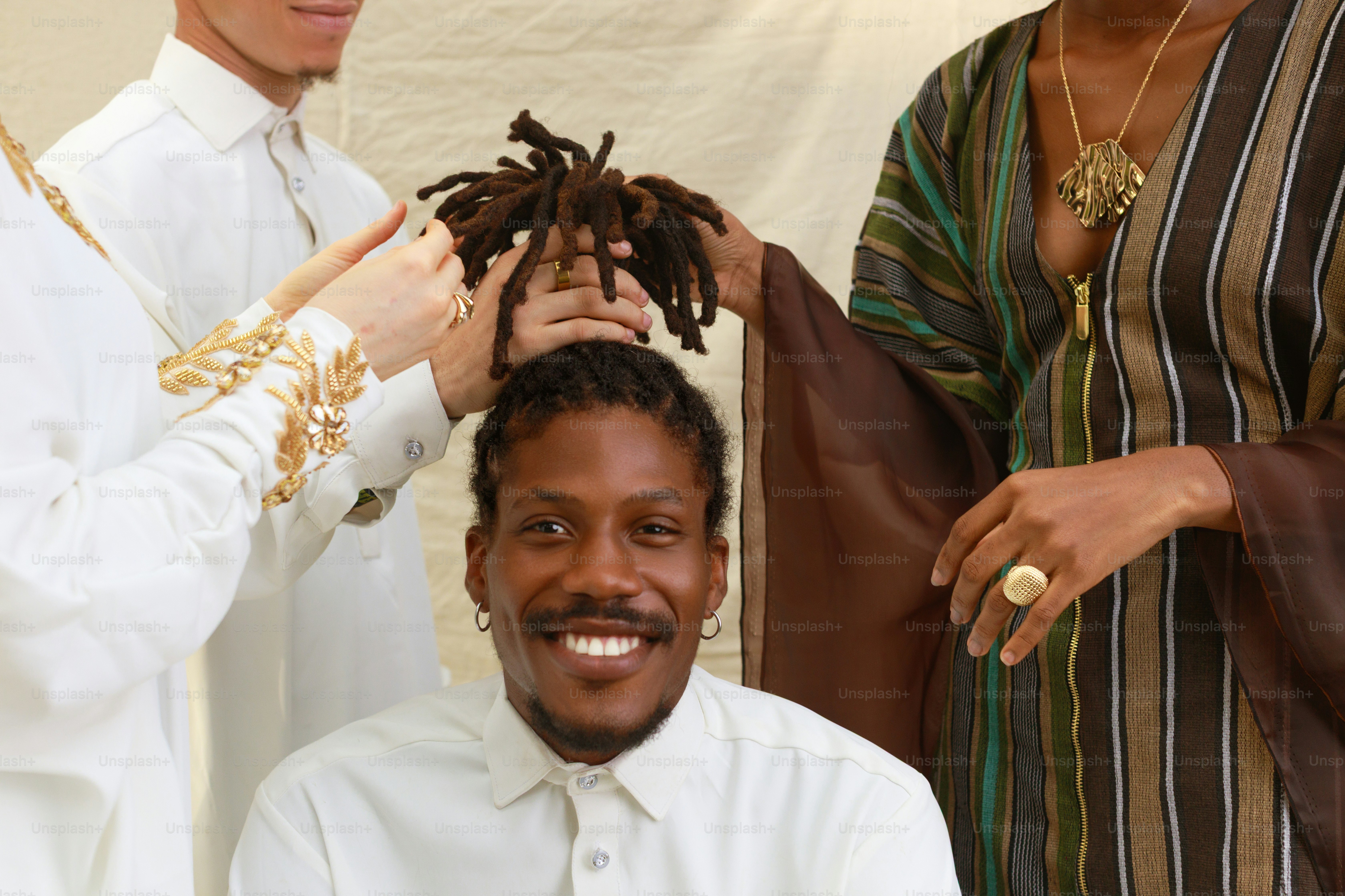 People styling a man's dreadlocks with smiles photo – Hair Image on ...