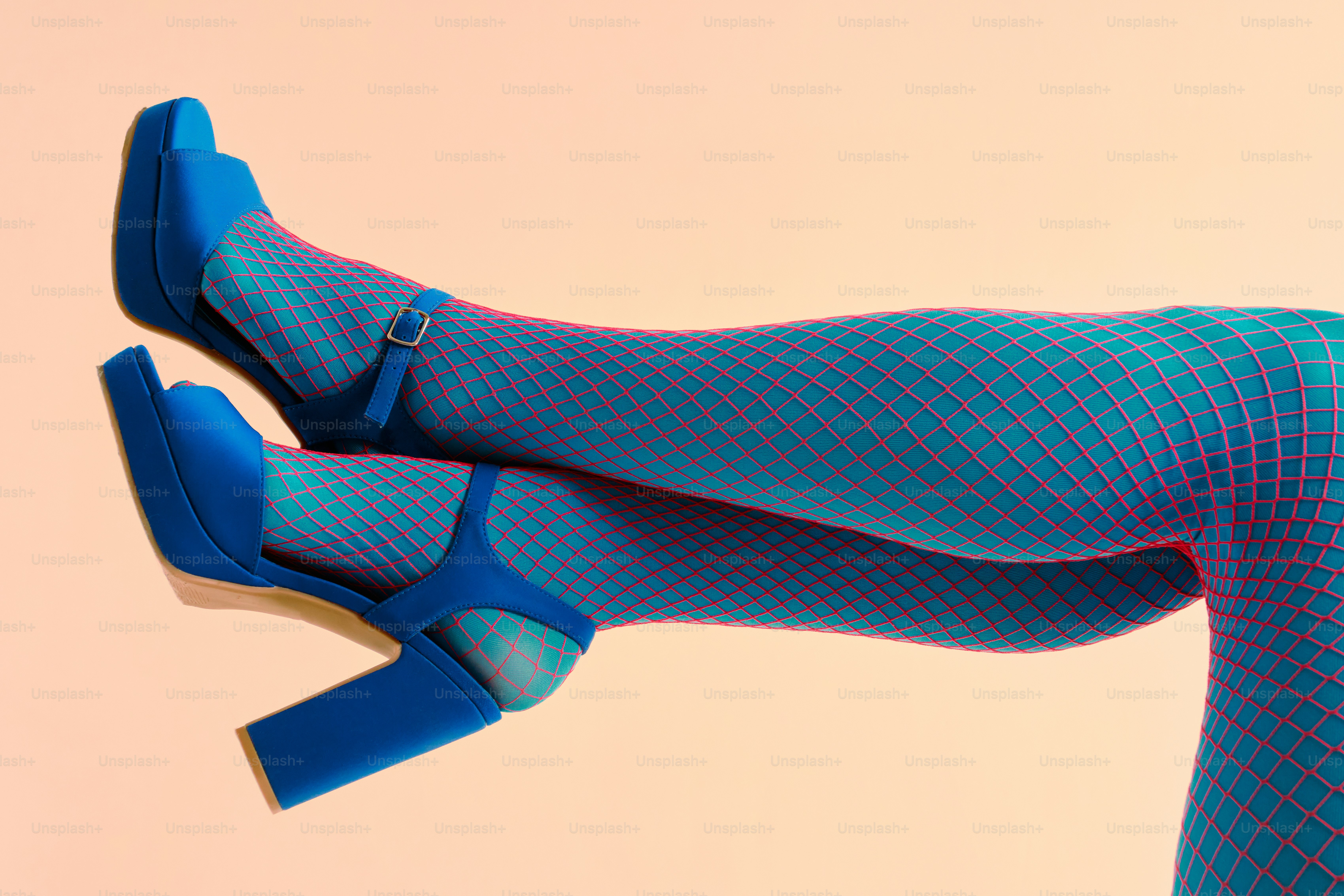 Blue platform heels on legs wearing fishnet tights