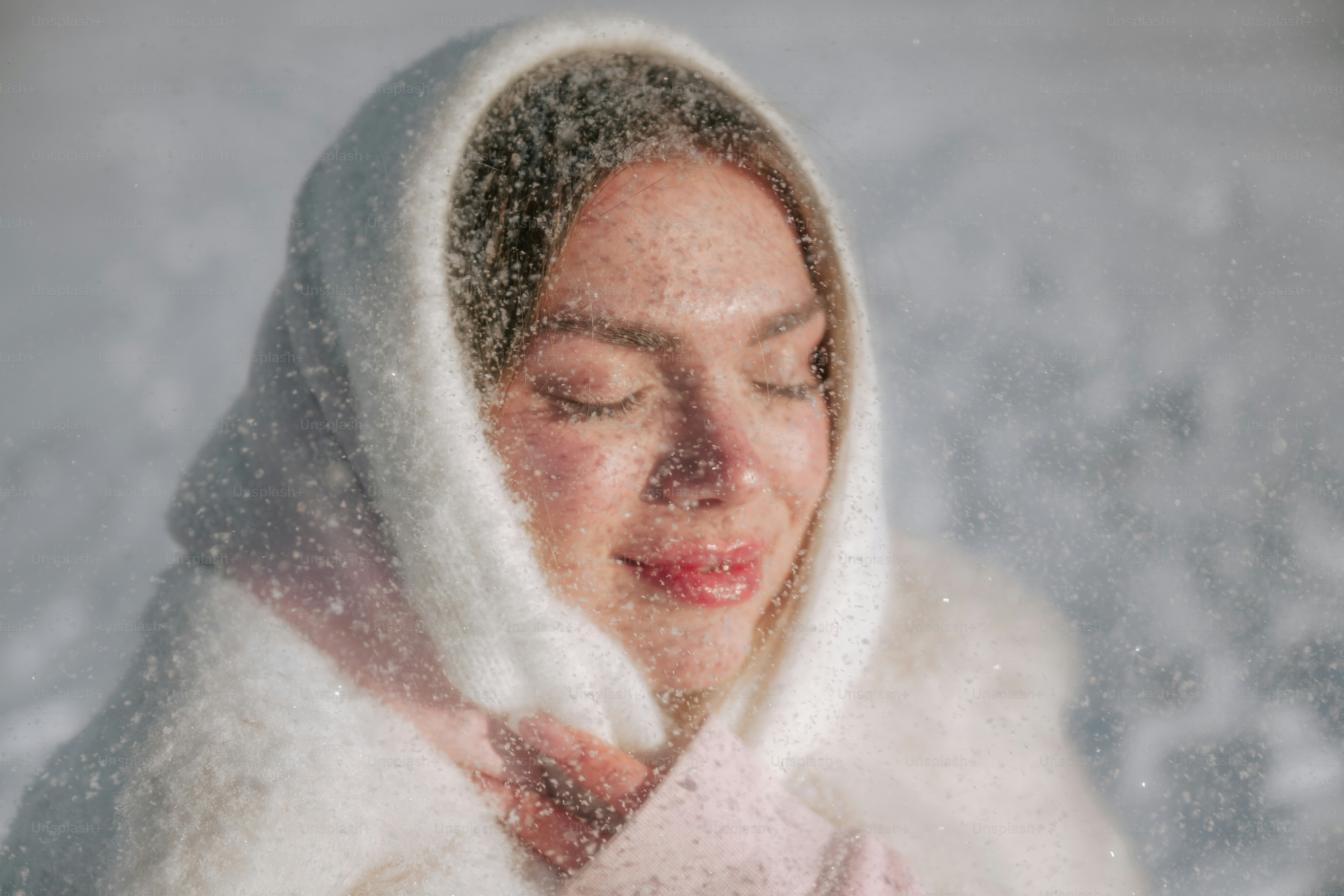 Woman in snow with eyes closed