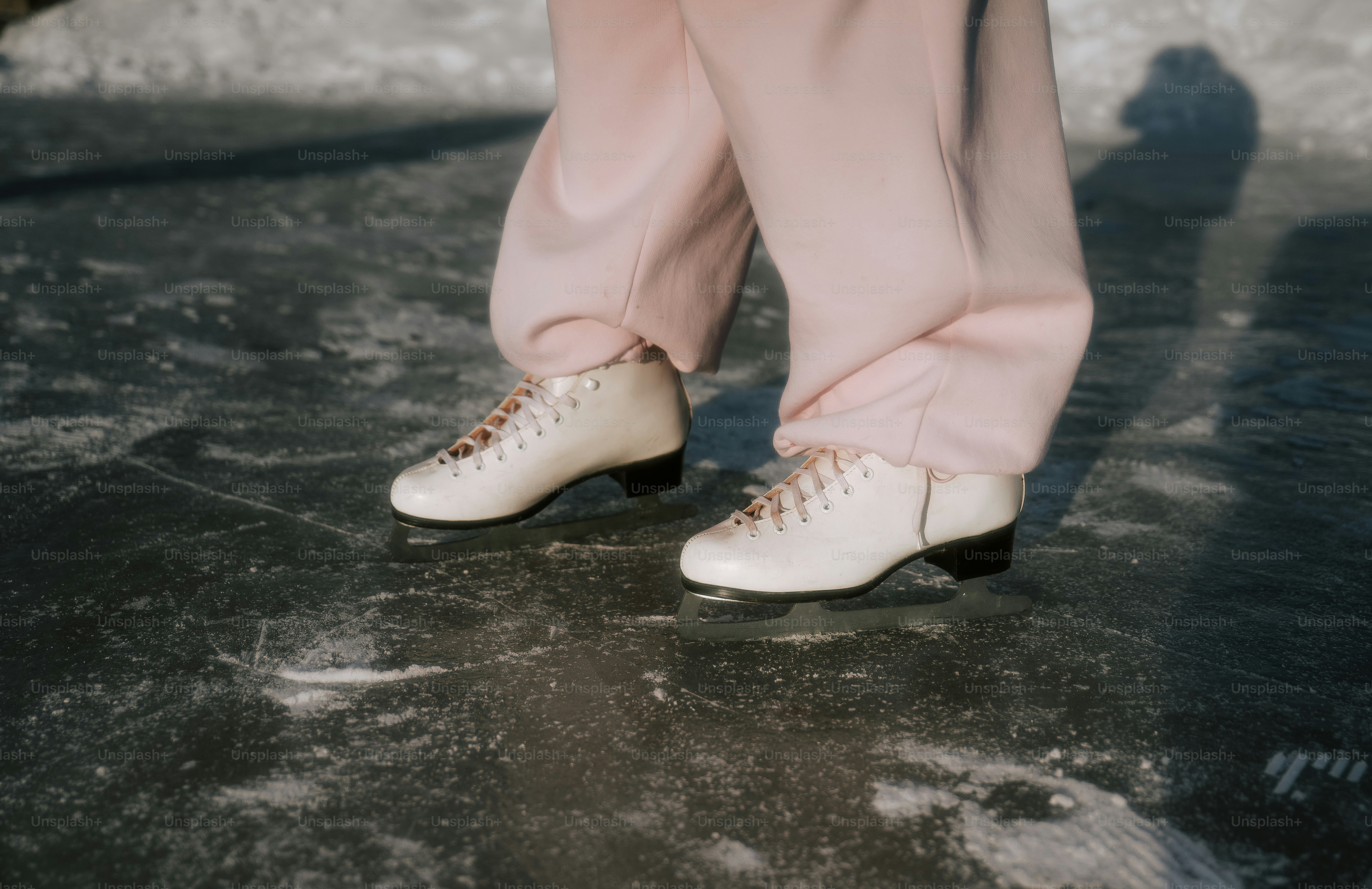 Person wearing ice skates on a frozen surface