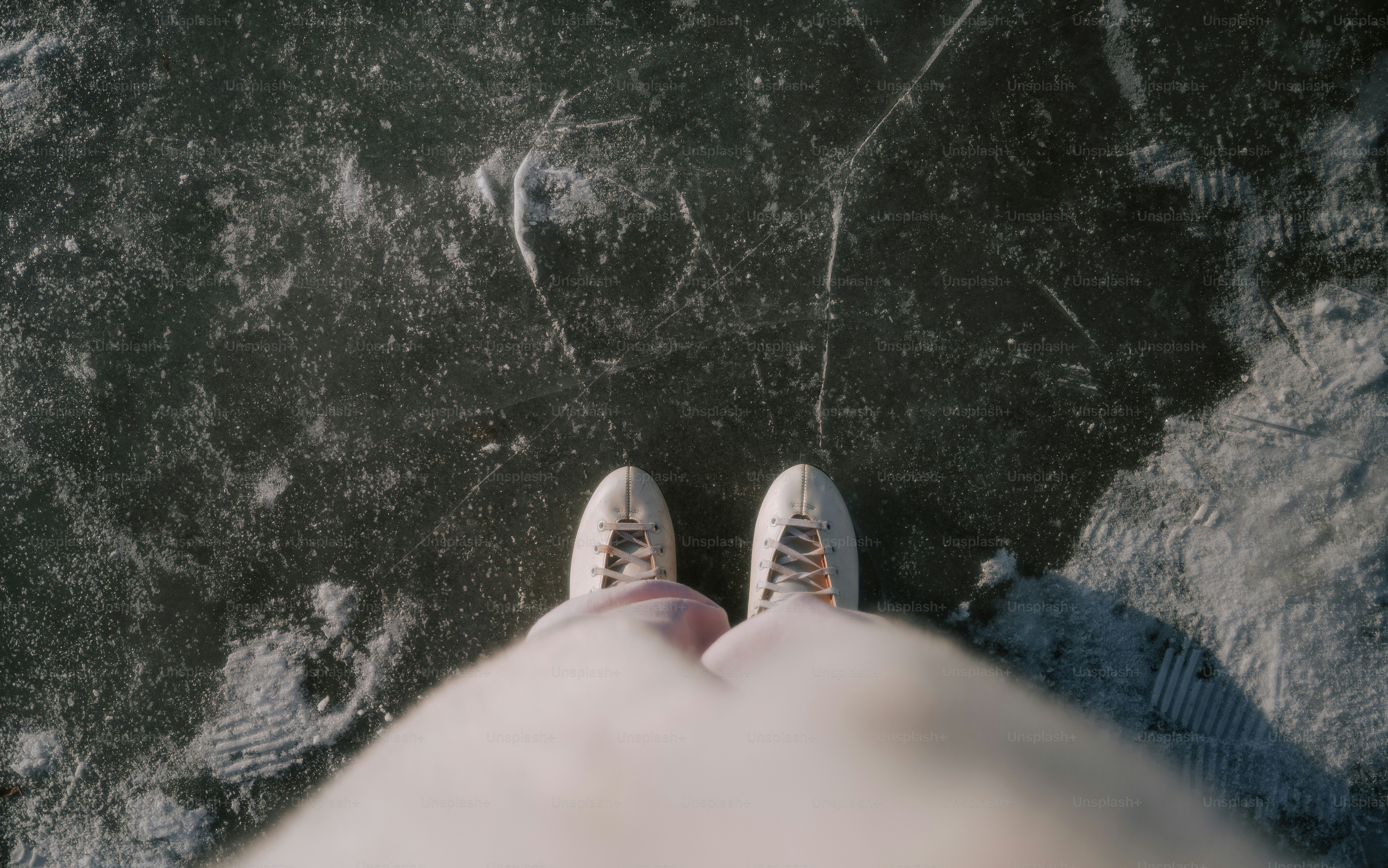 Person wearing ice skates on frozen surface