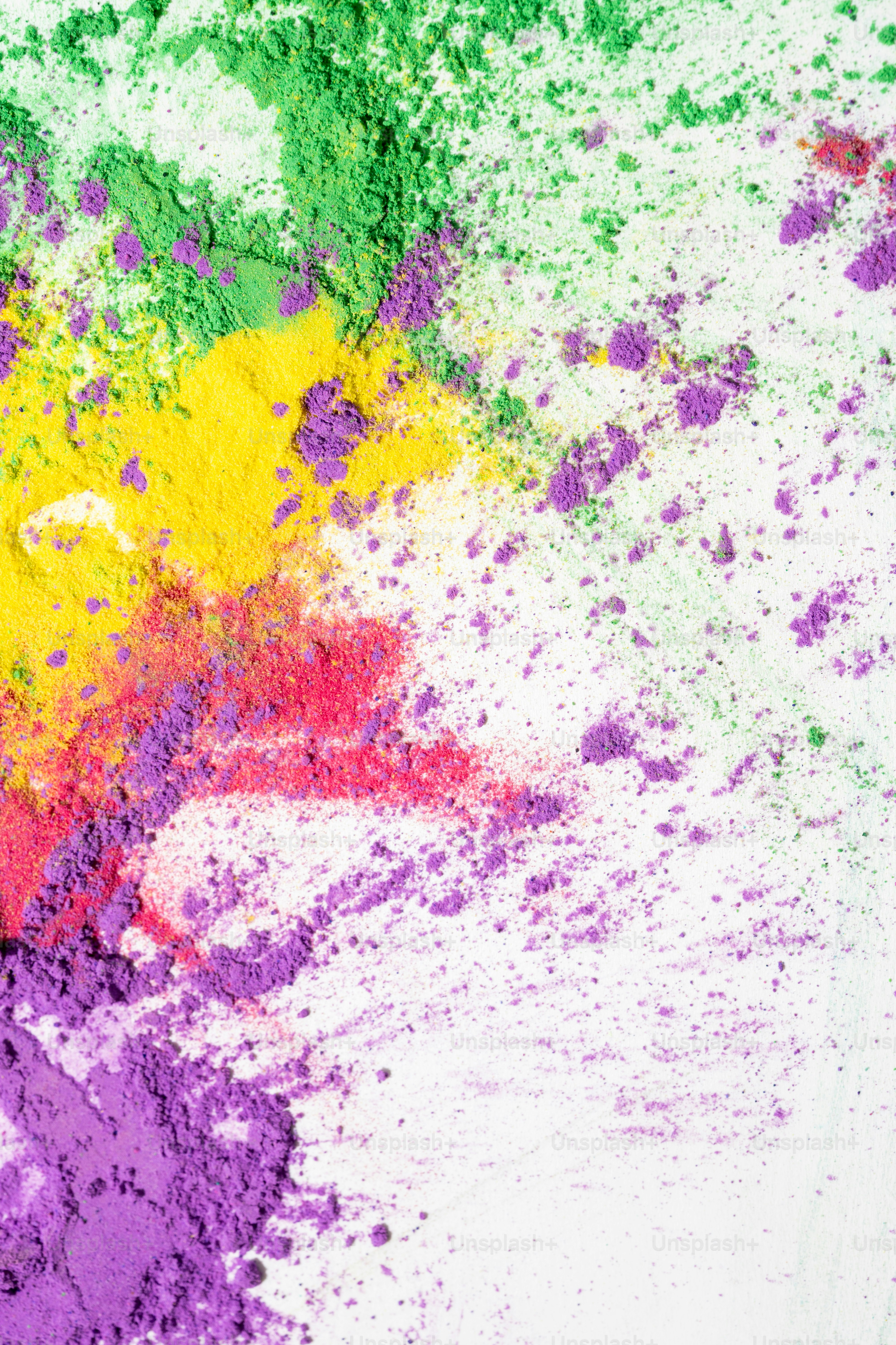 Colorful holi powder scattered on a white surface
