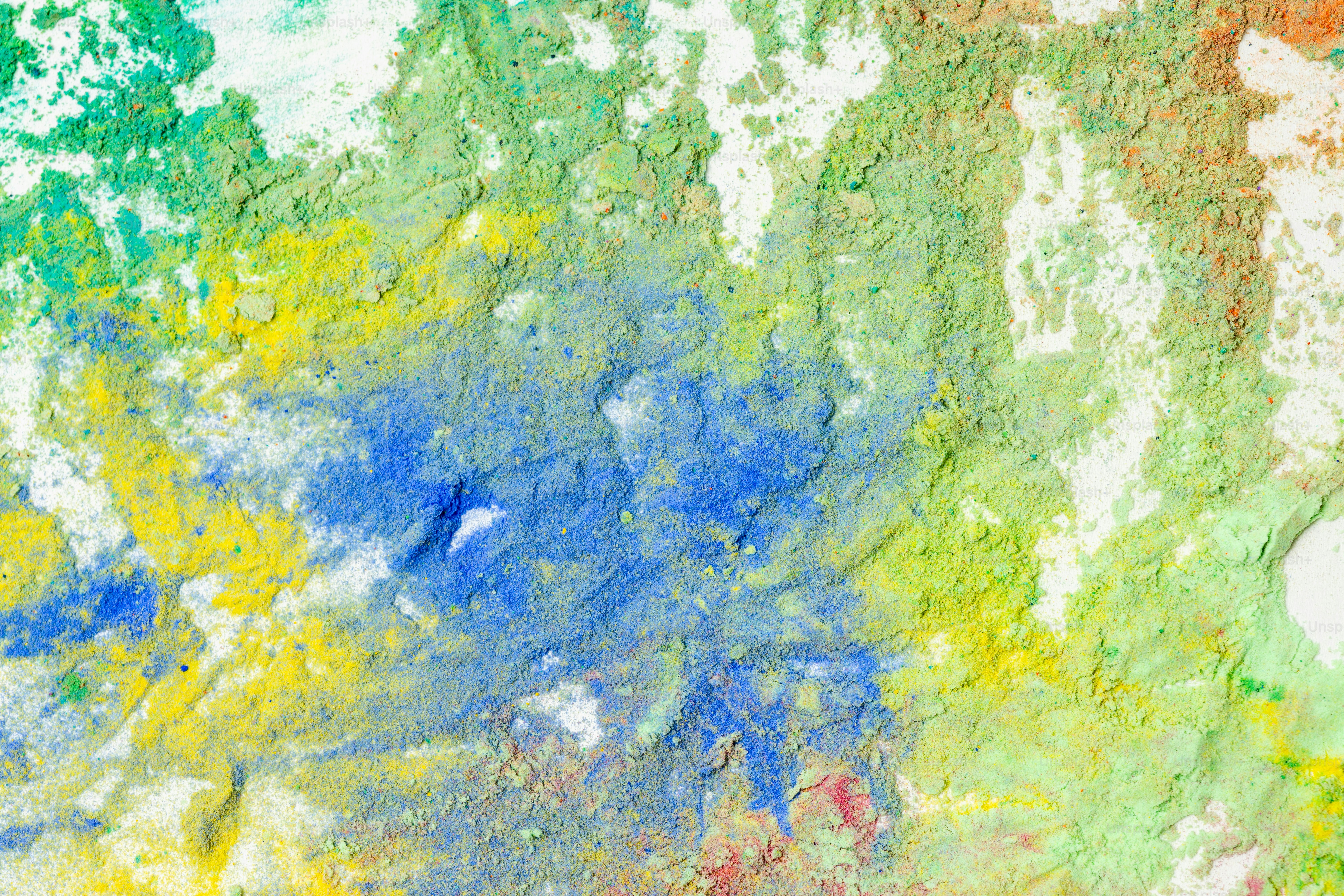 Abstract texture with green, yellow, and blue paint.