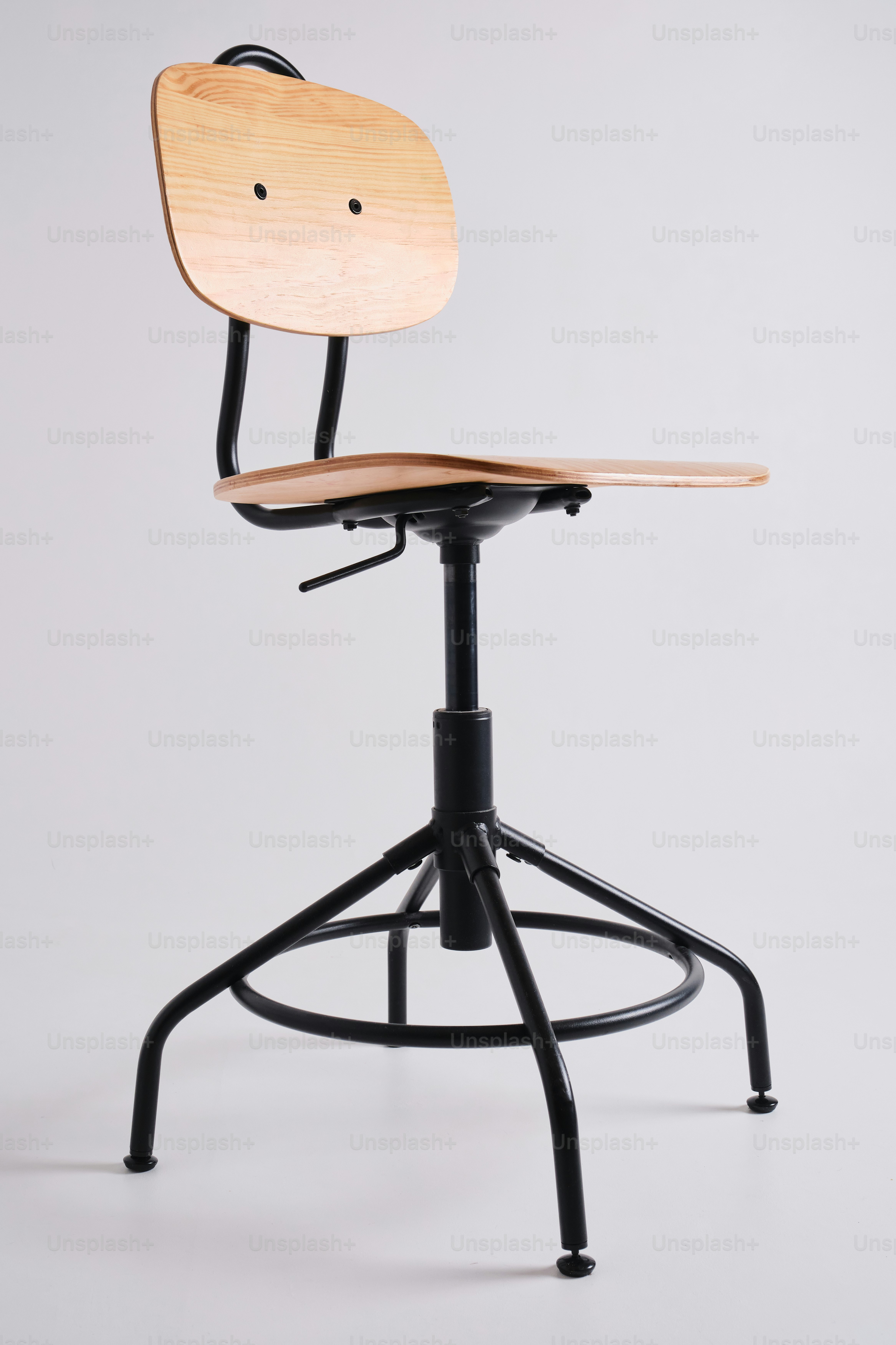 A modern wooden and black metal adjustable stool