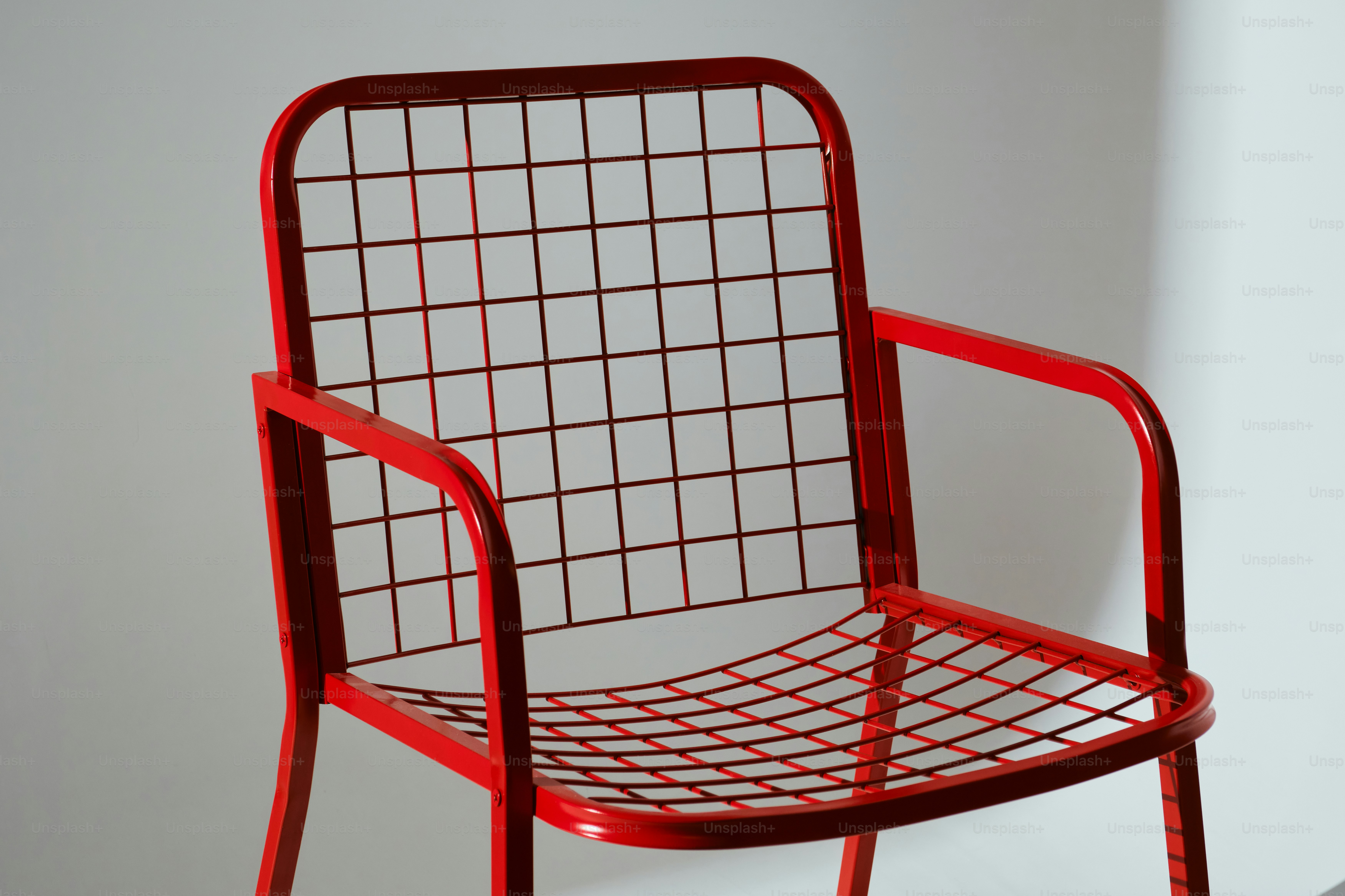 A red metal chair with a grid pattern