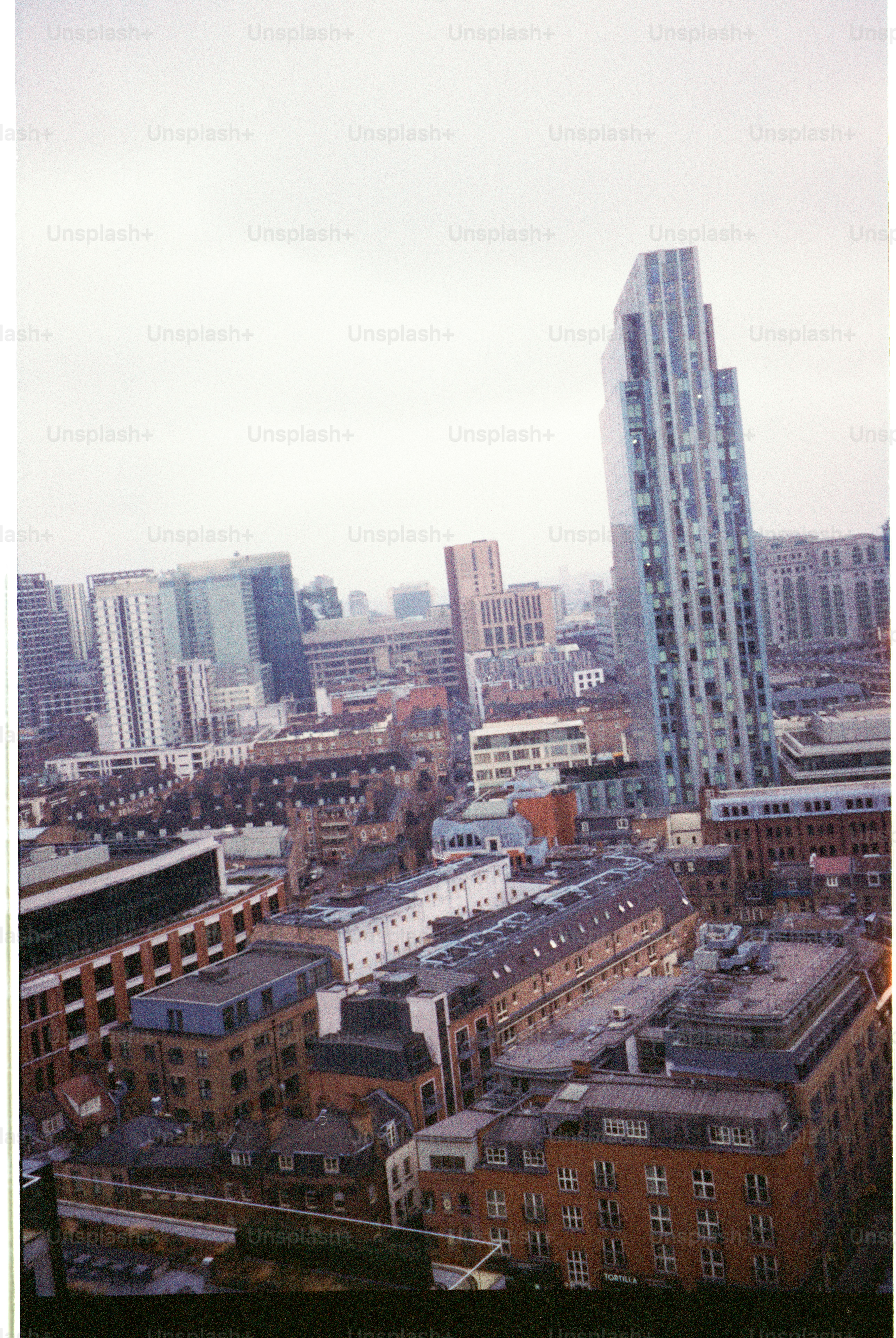 Modern skyscrapers rise above older city buildings.