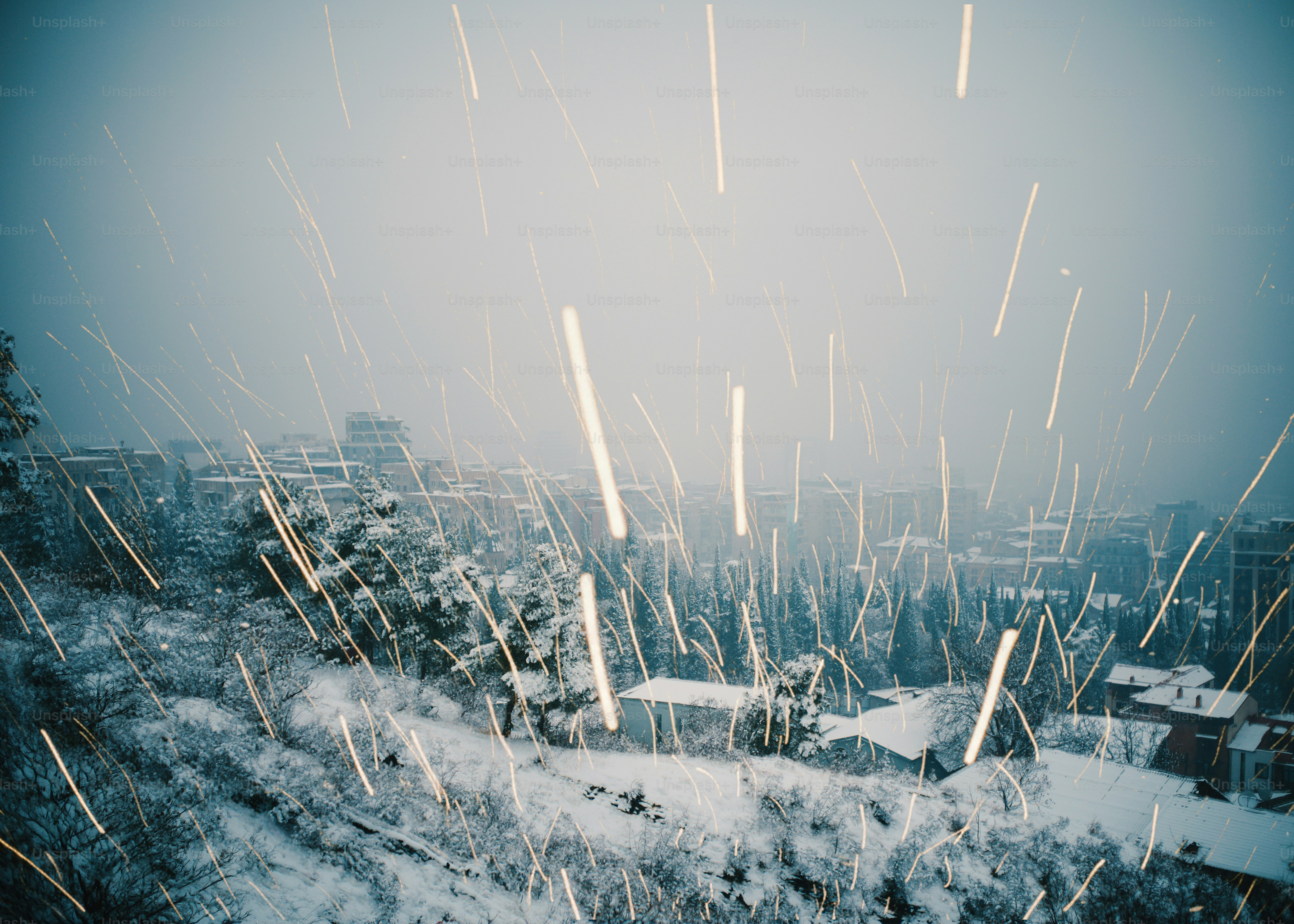 Streaks of light fall on a snowy landscape