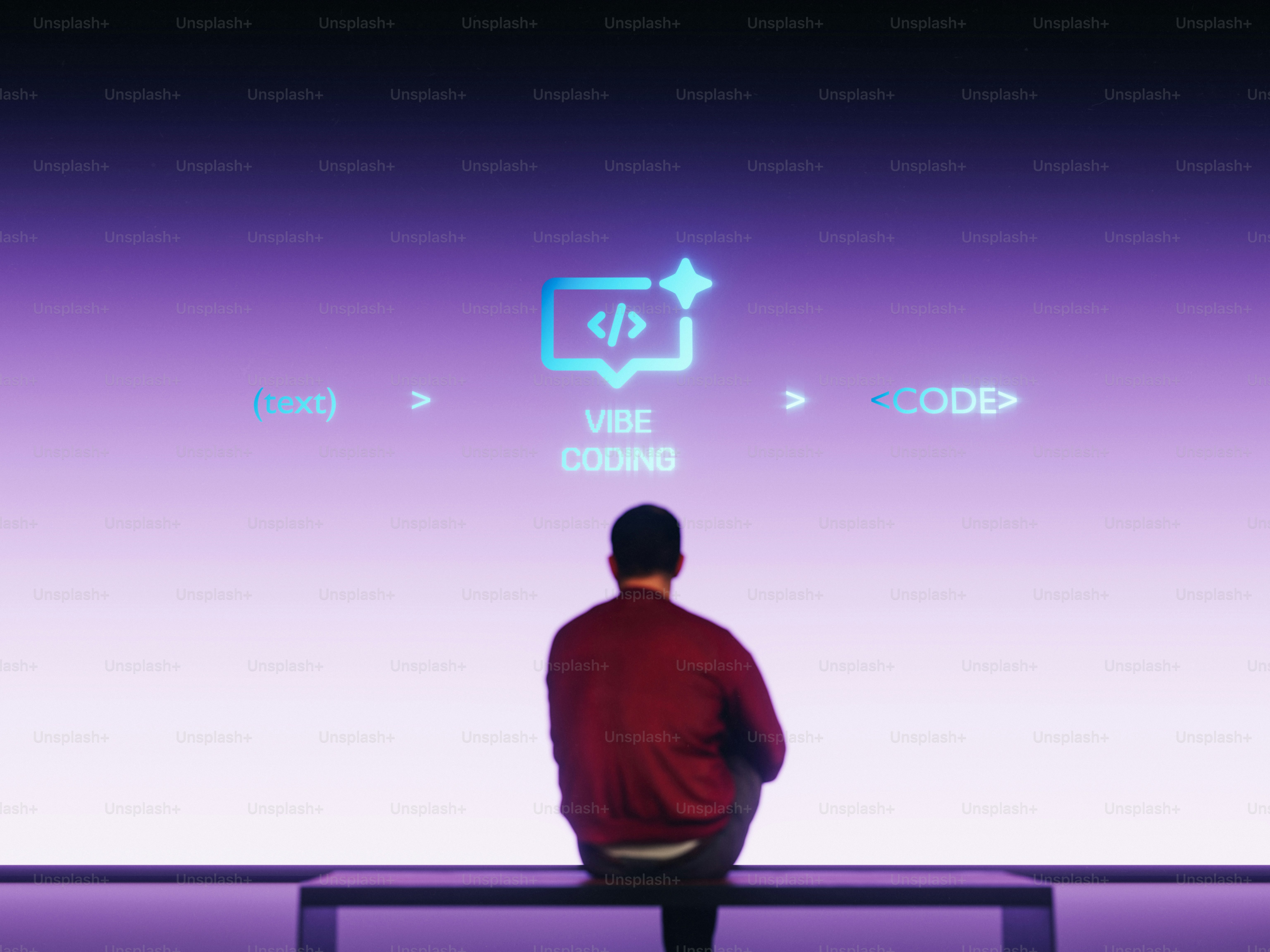 Man sitting in front of a screen with code