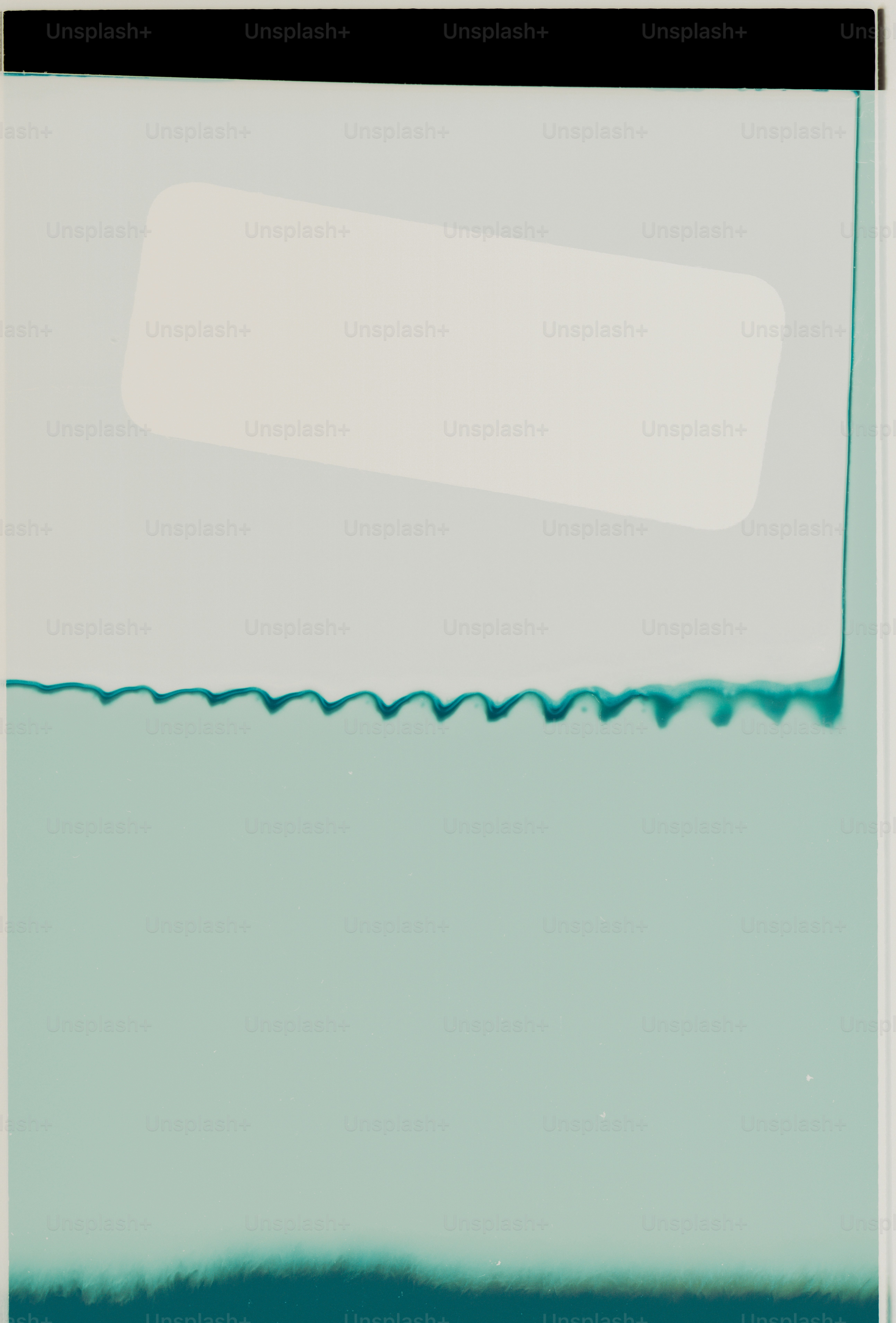 White rectangle on a light blue background with green streaks.