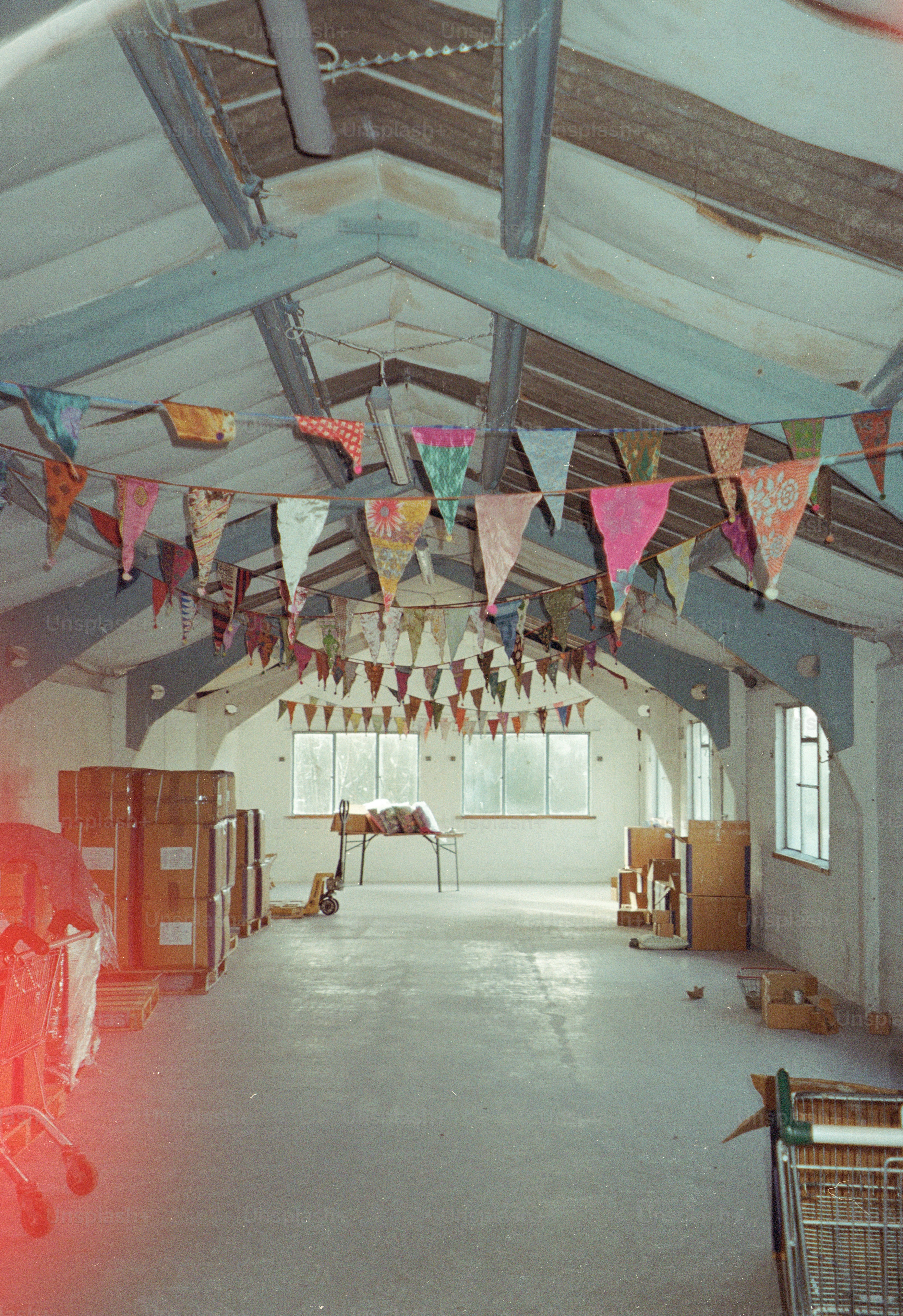 Empty warehouse decorated with colorful bunting and boxes