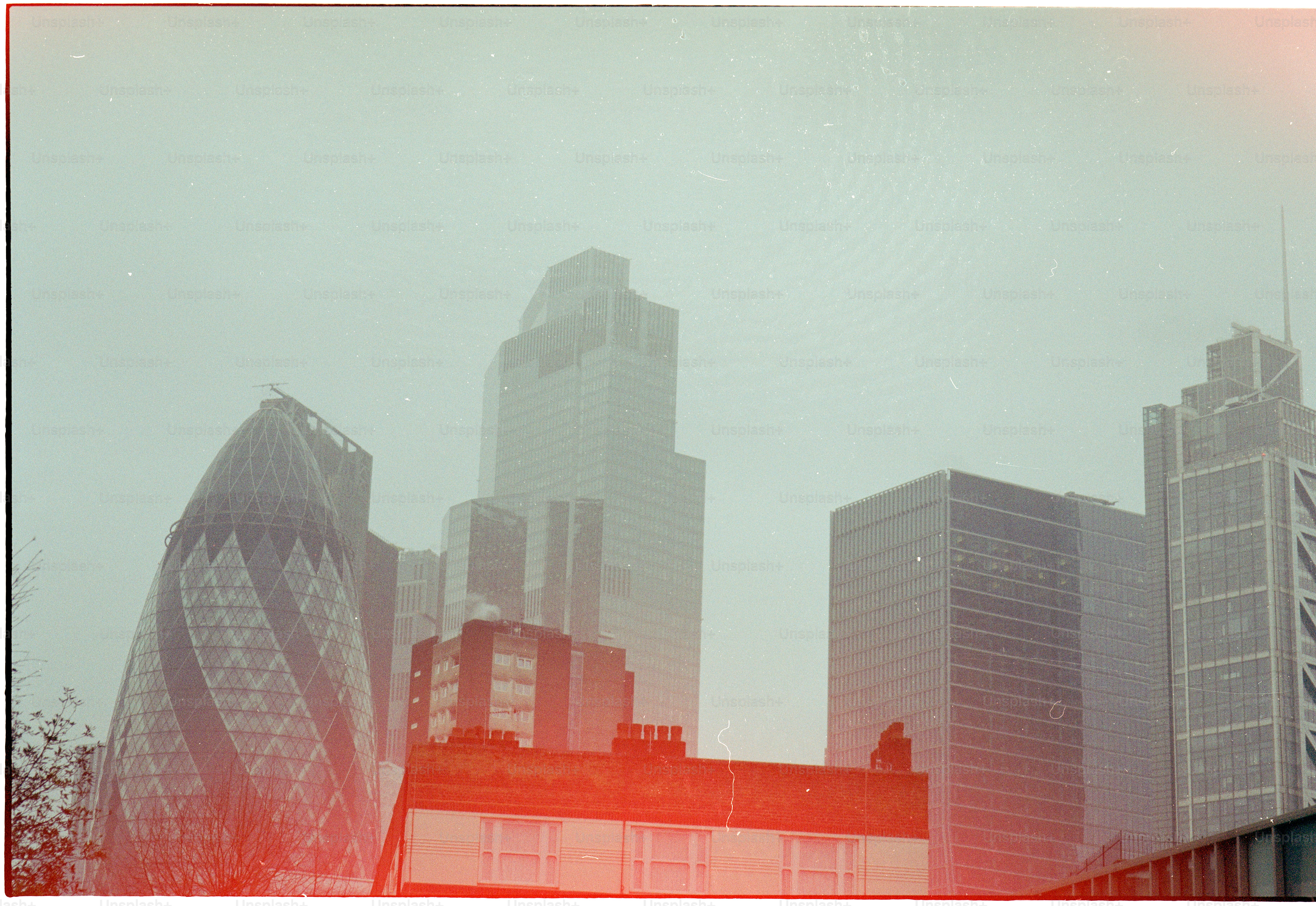 Modern skyscrapers in a hazy city skyline.