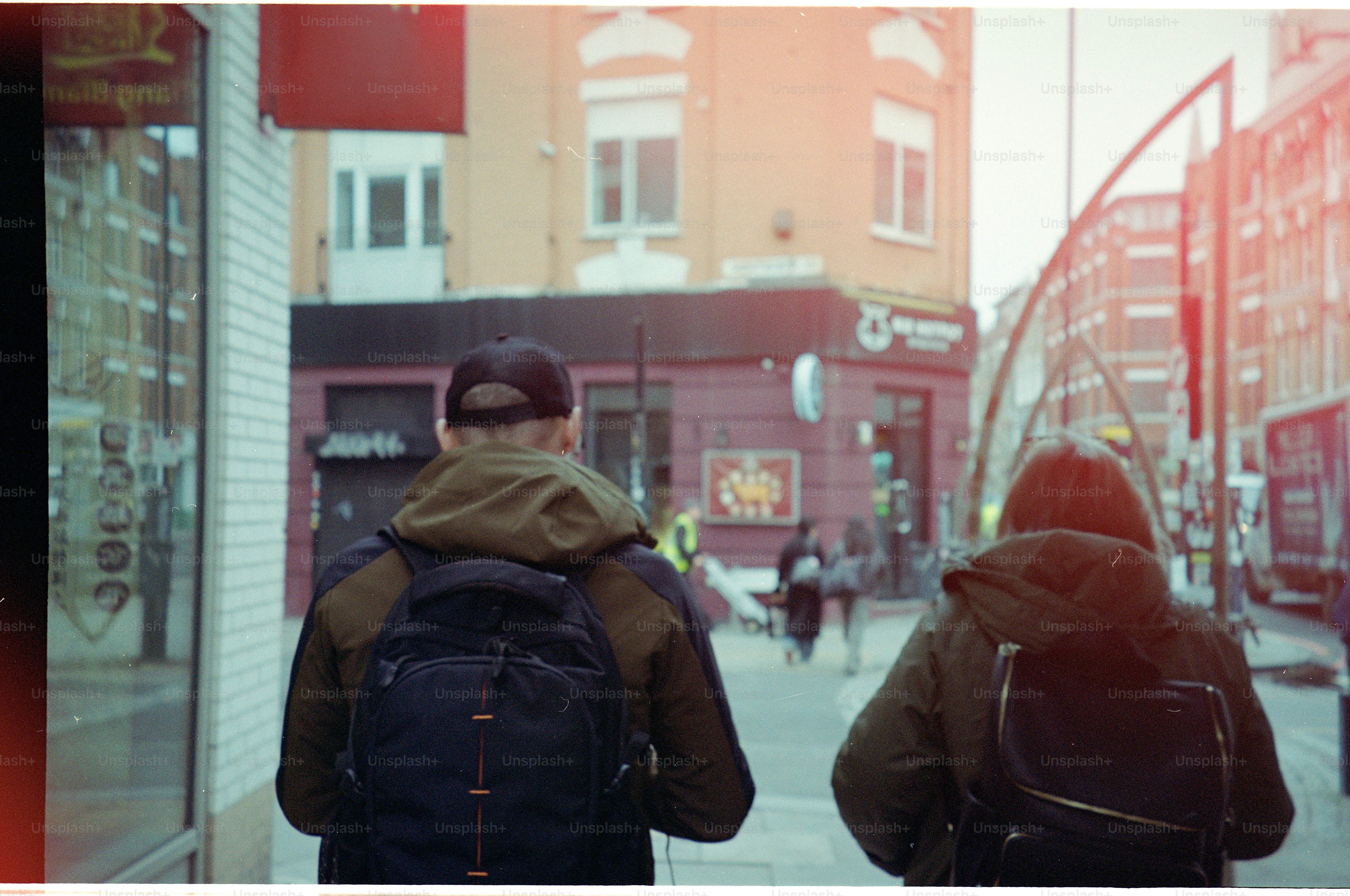 Two people walking down a city street