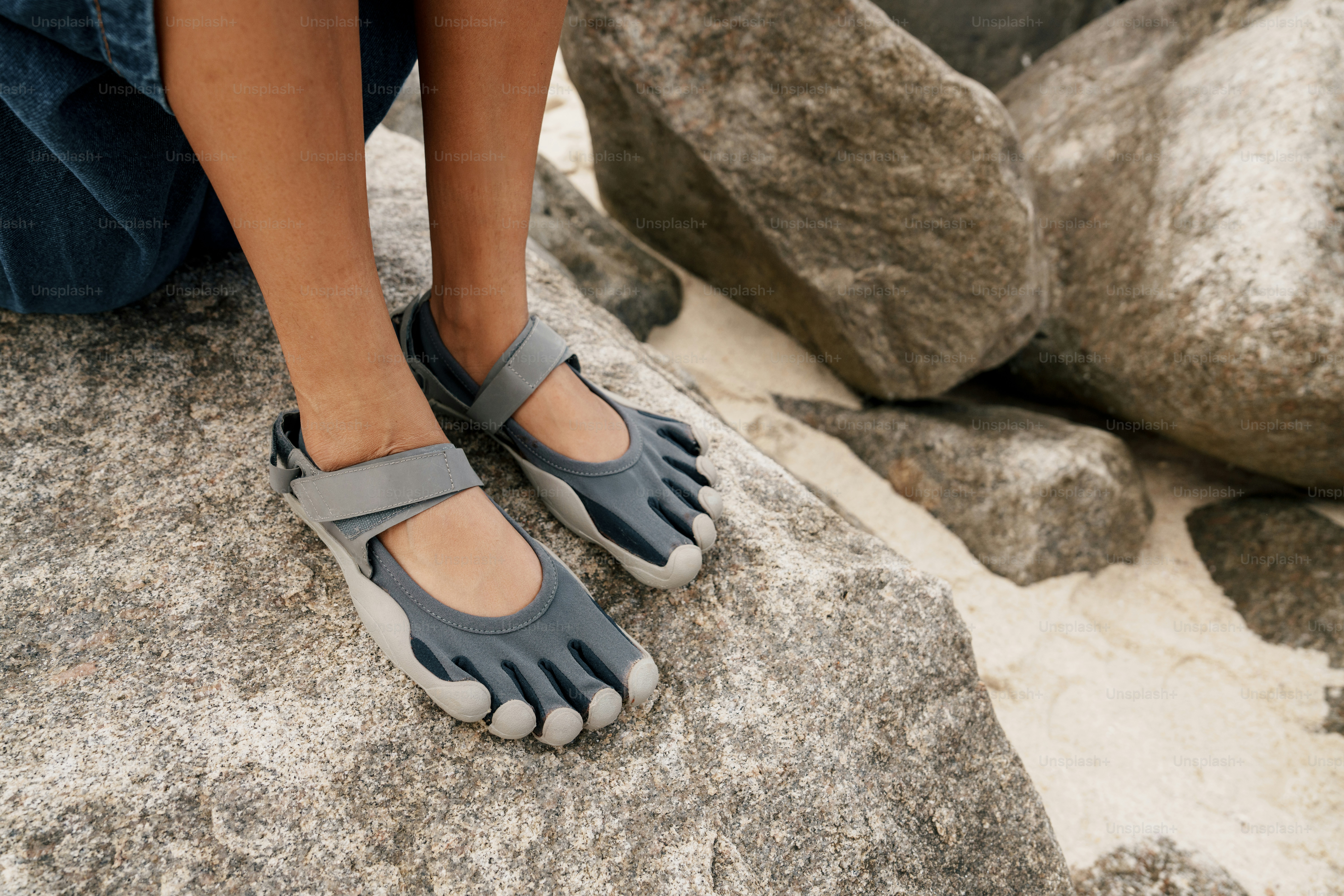 Person wearing minimalist toe shoes on rocks photo – Active lifestyle ...