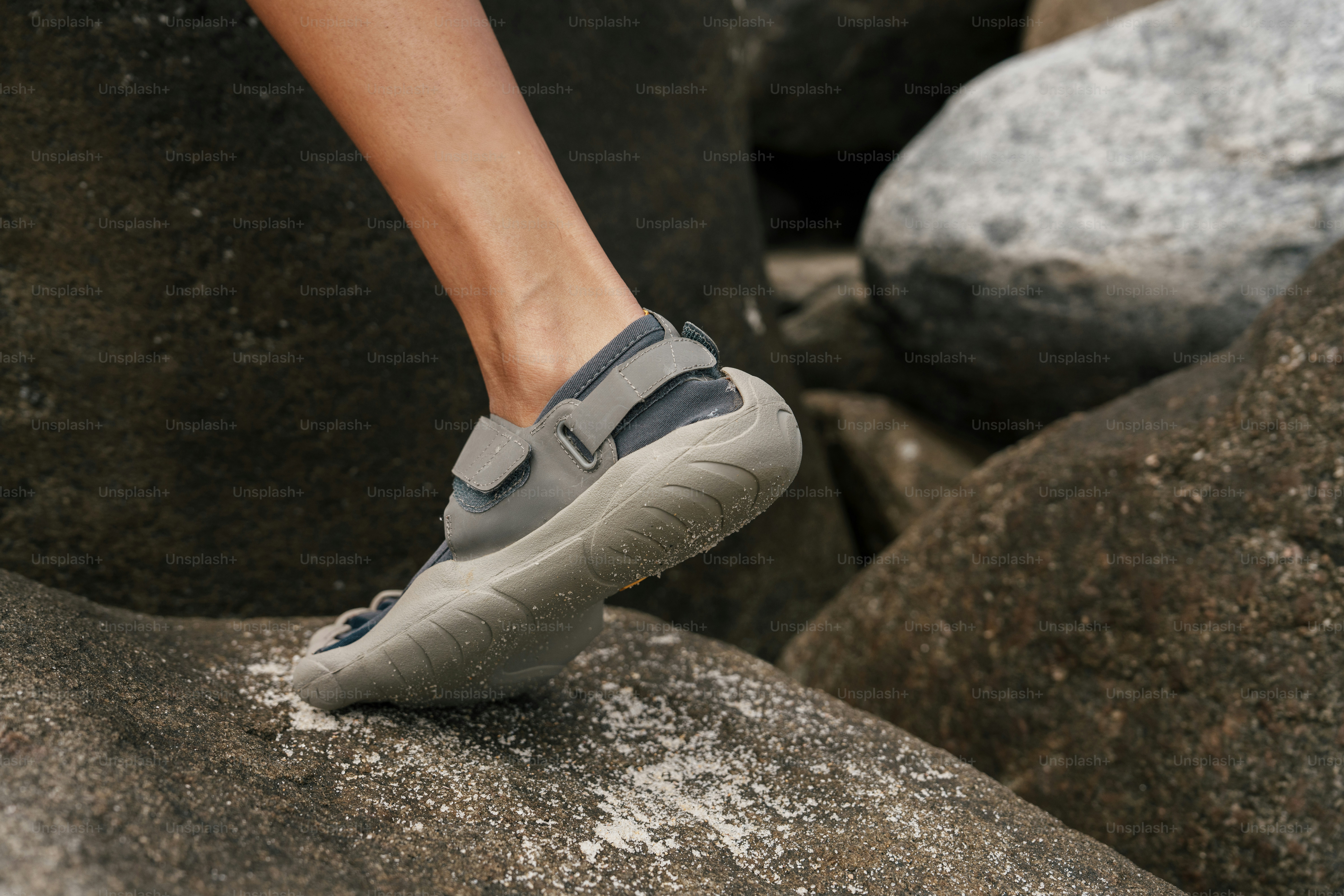 Person wearing minimalist toe shoes on rocks photo – Active lifestyle ...