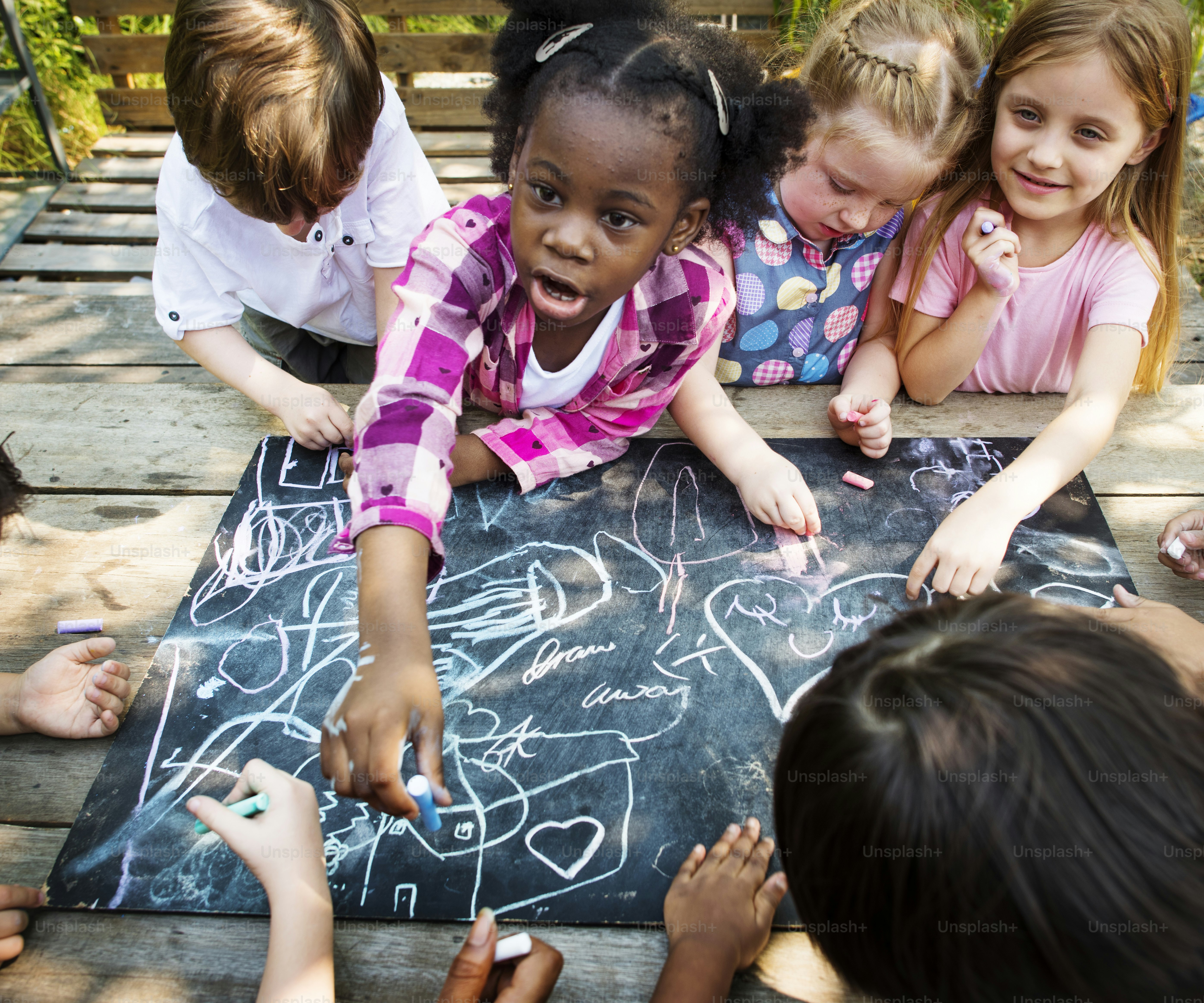 Group of kindergarten kids friends drawing art class outdoors