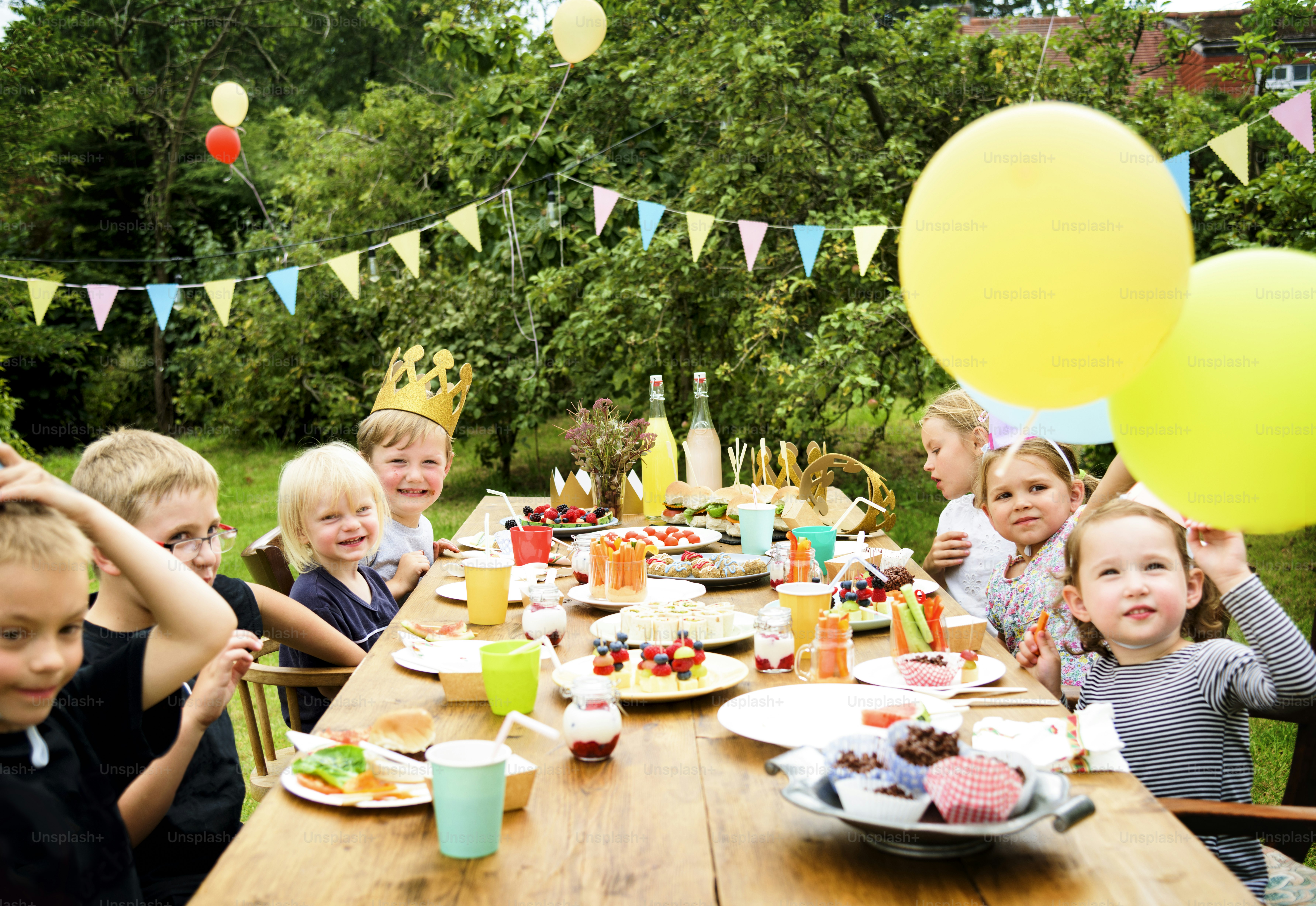 Child celebrating a birthday party with balloons