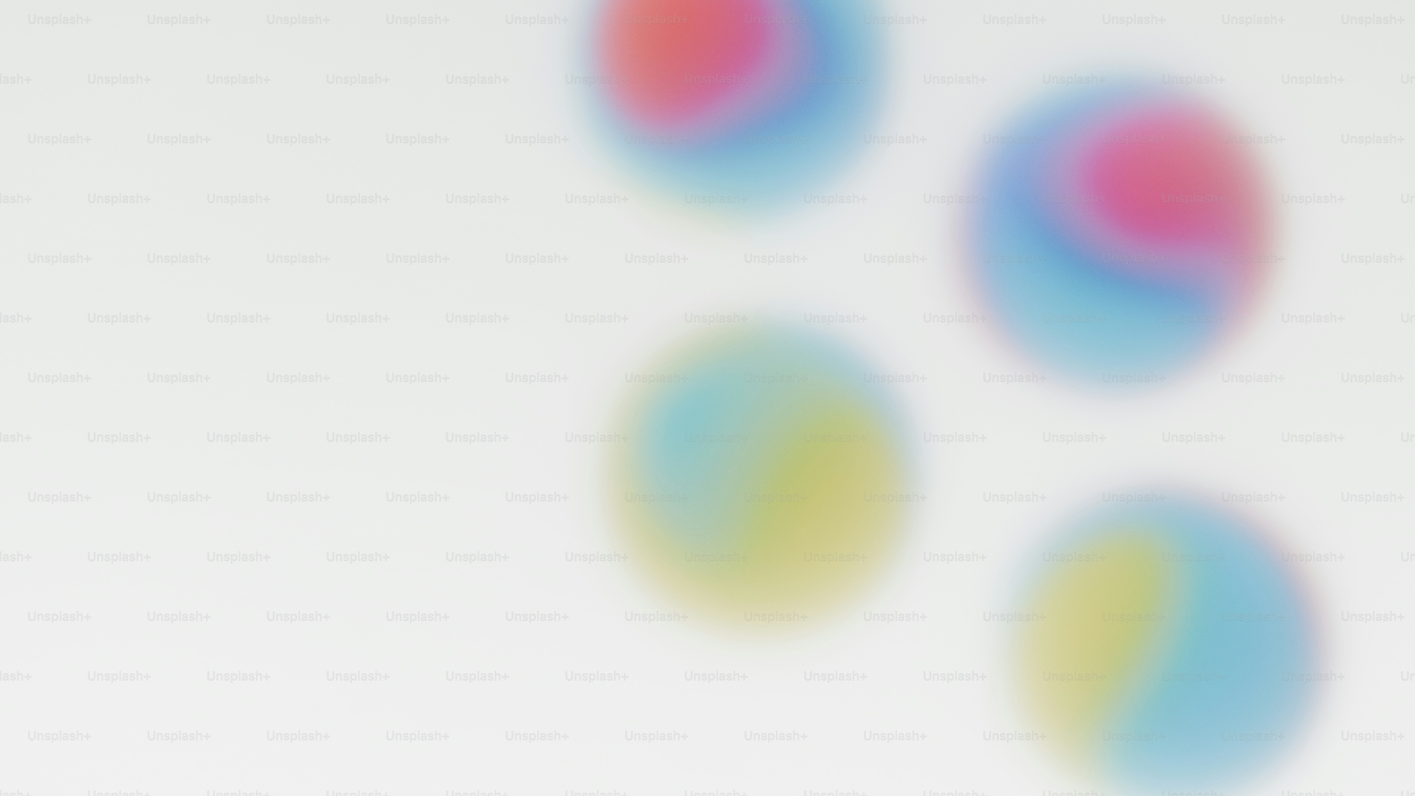 Four colorful blurred balls on a white background