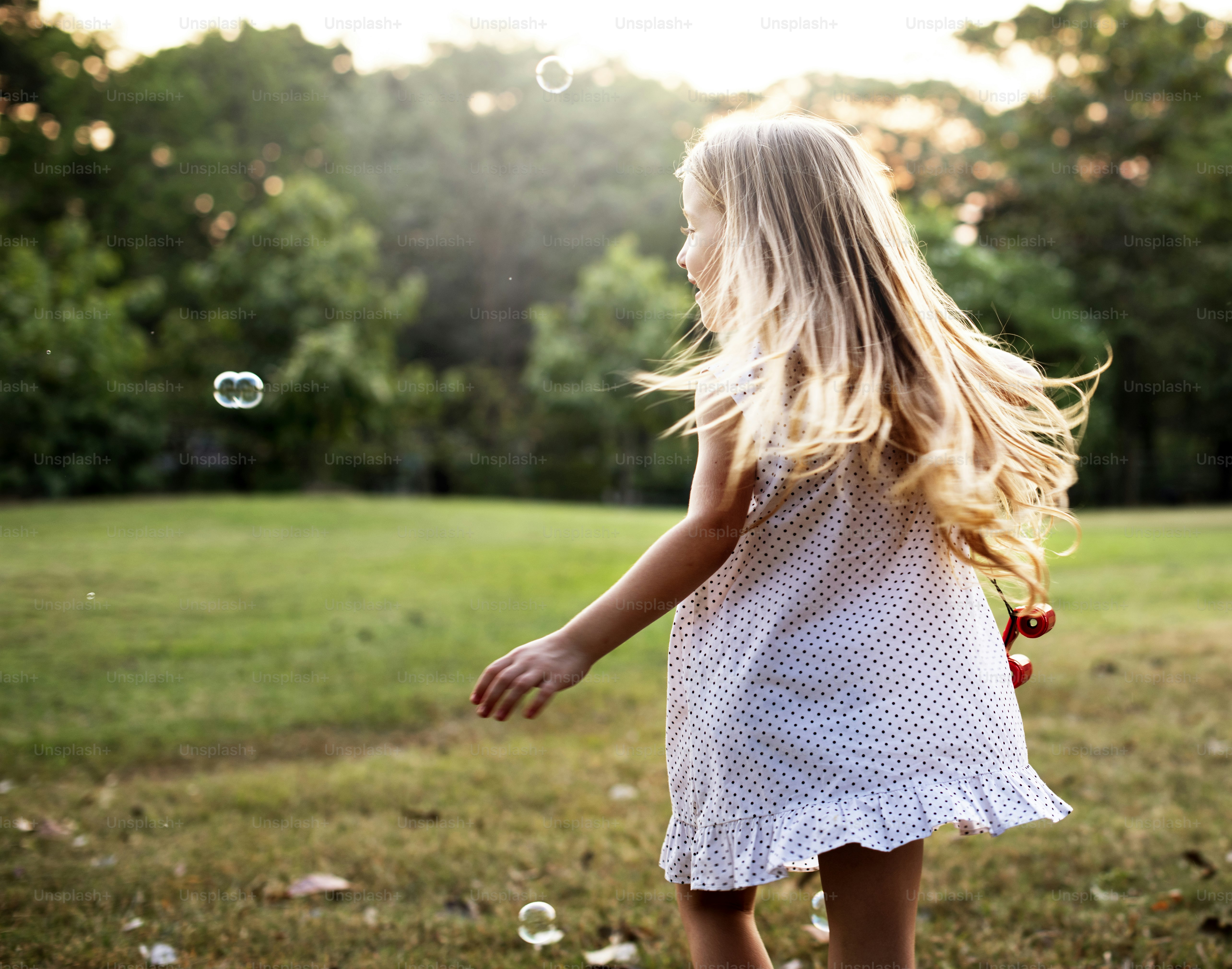 Caucasian blonde girl playing in a park