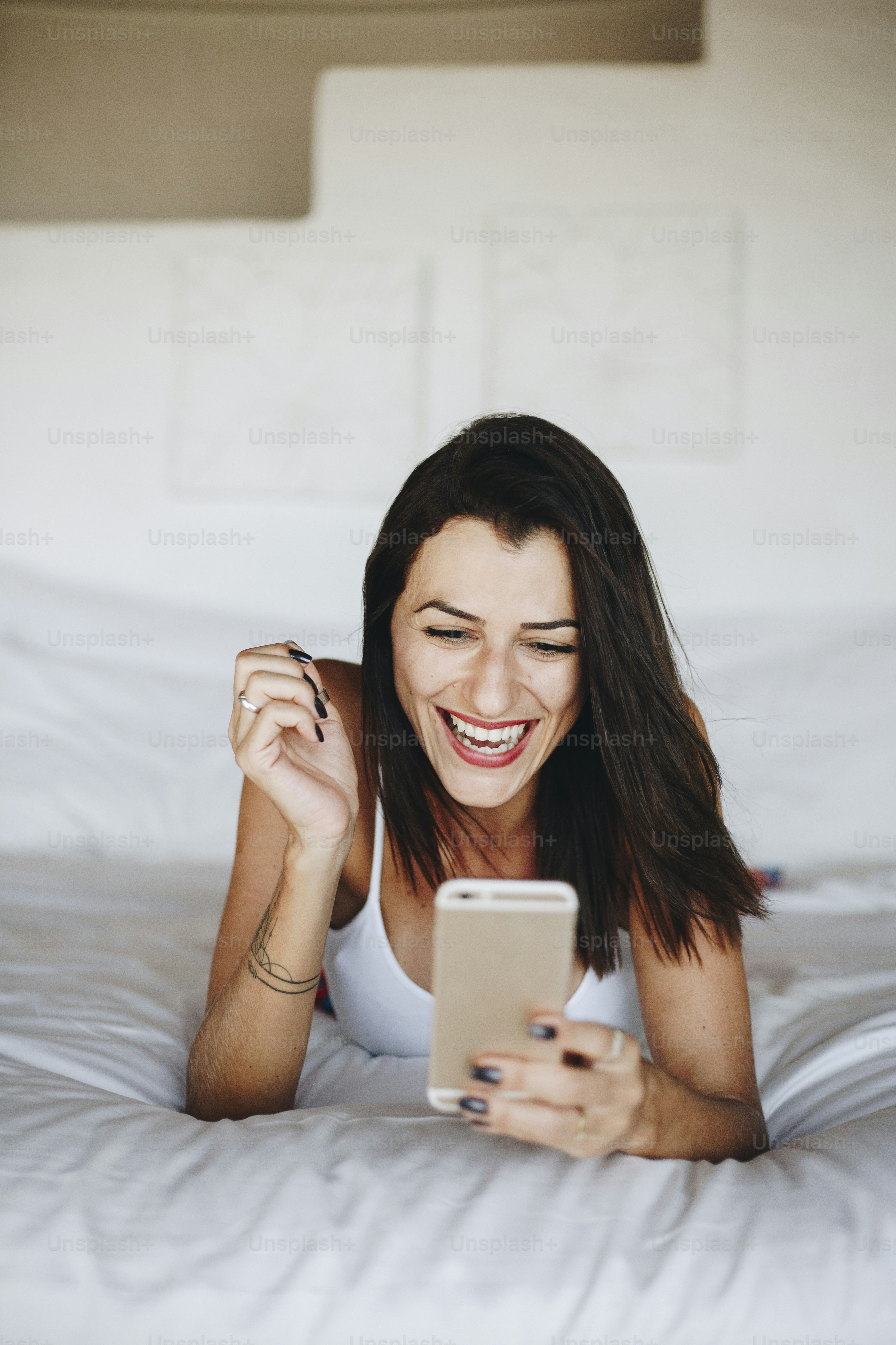 Woman using a mobile phone in bed