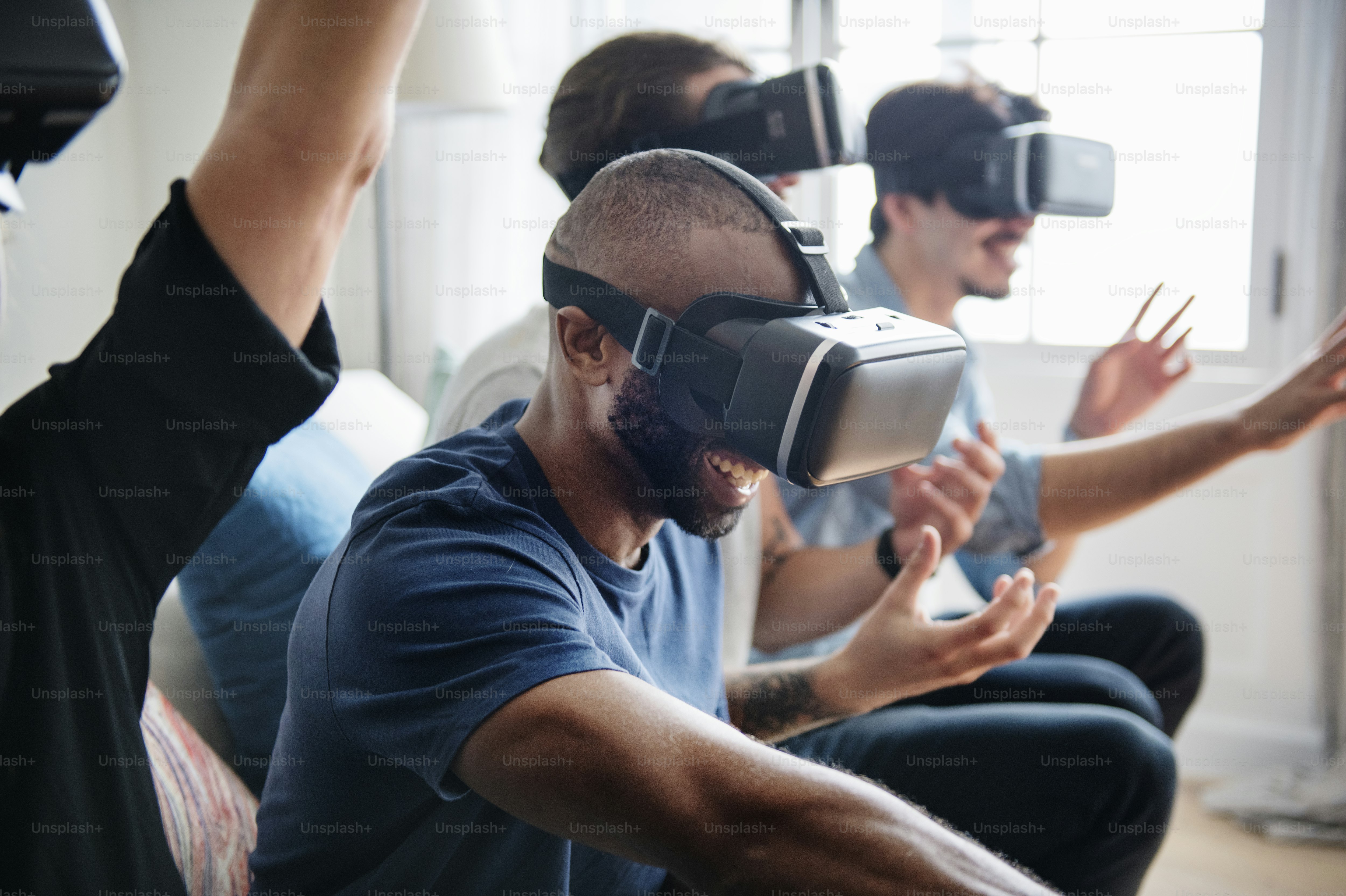 Group of diverse friends experiencing virtual reality with VR headset ...