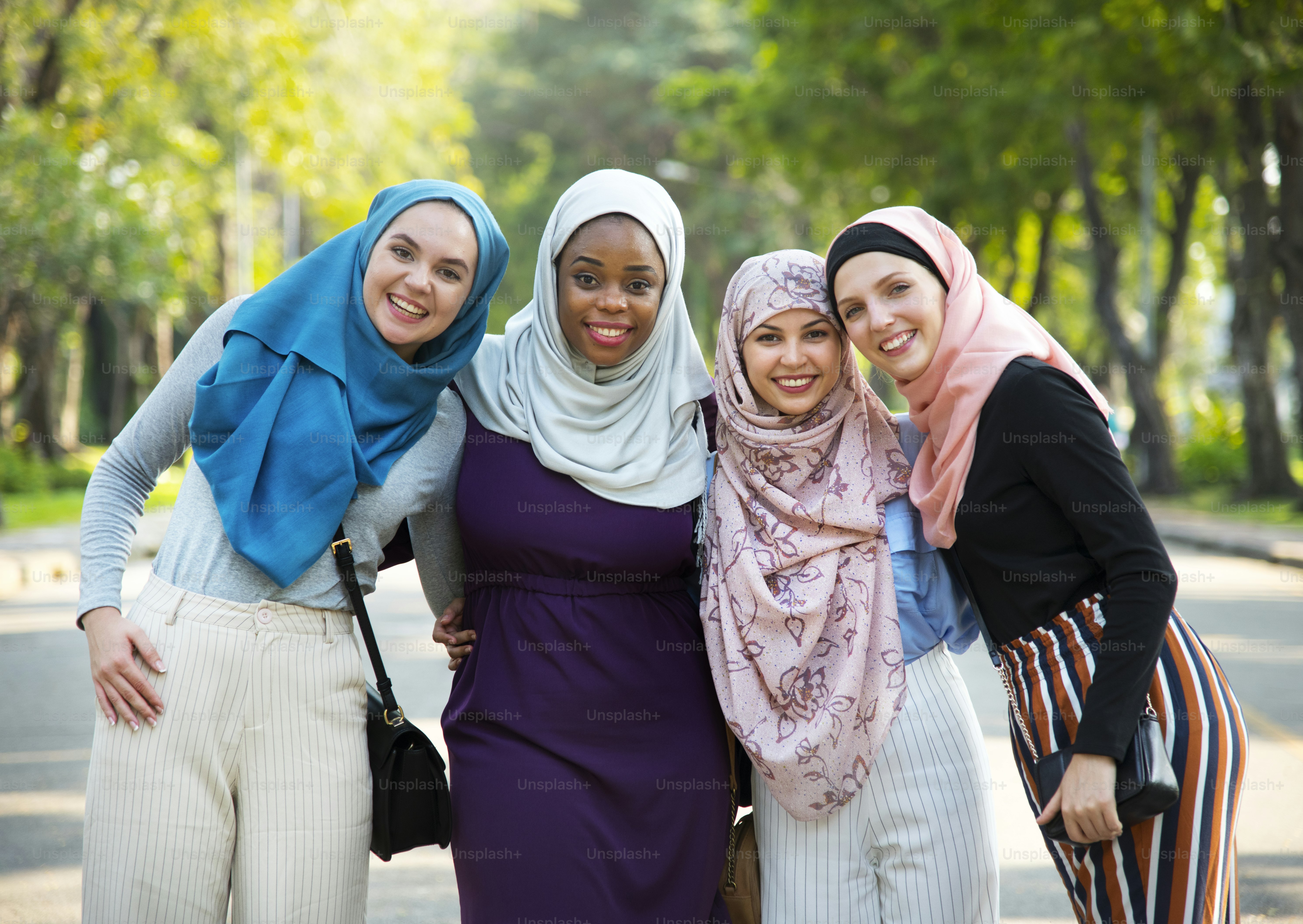 Group of islamic friends embracing and smiling together at park