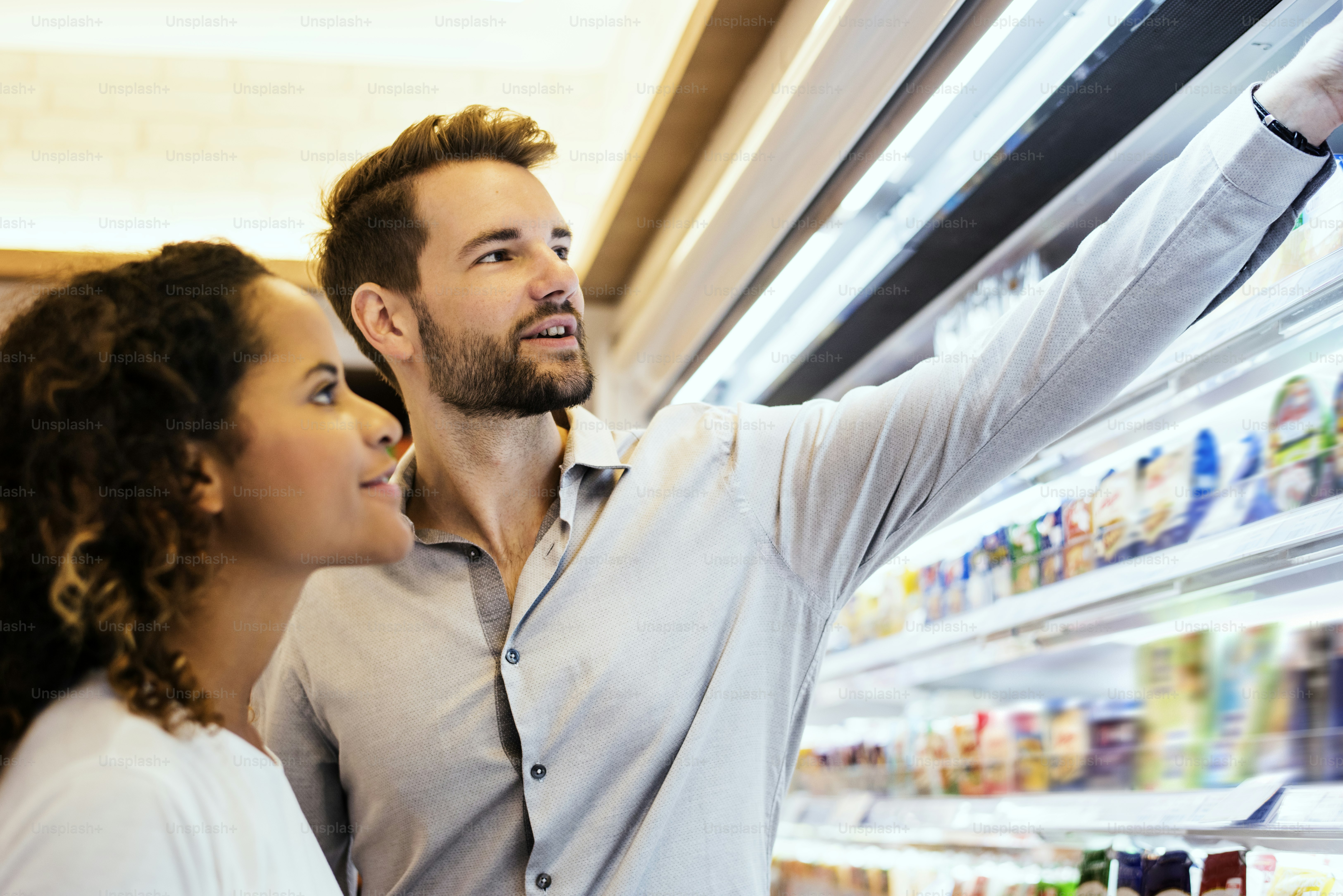 family arranging fridge storage with labeled containers and fresh produce
