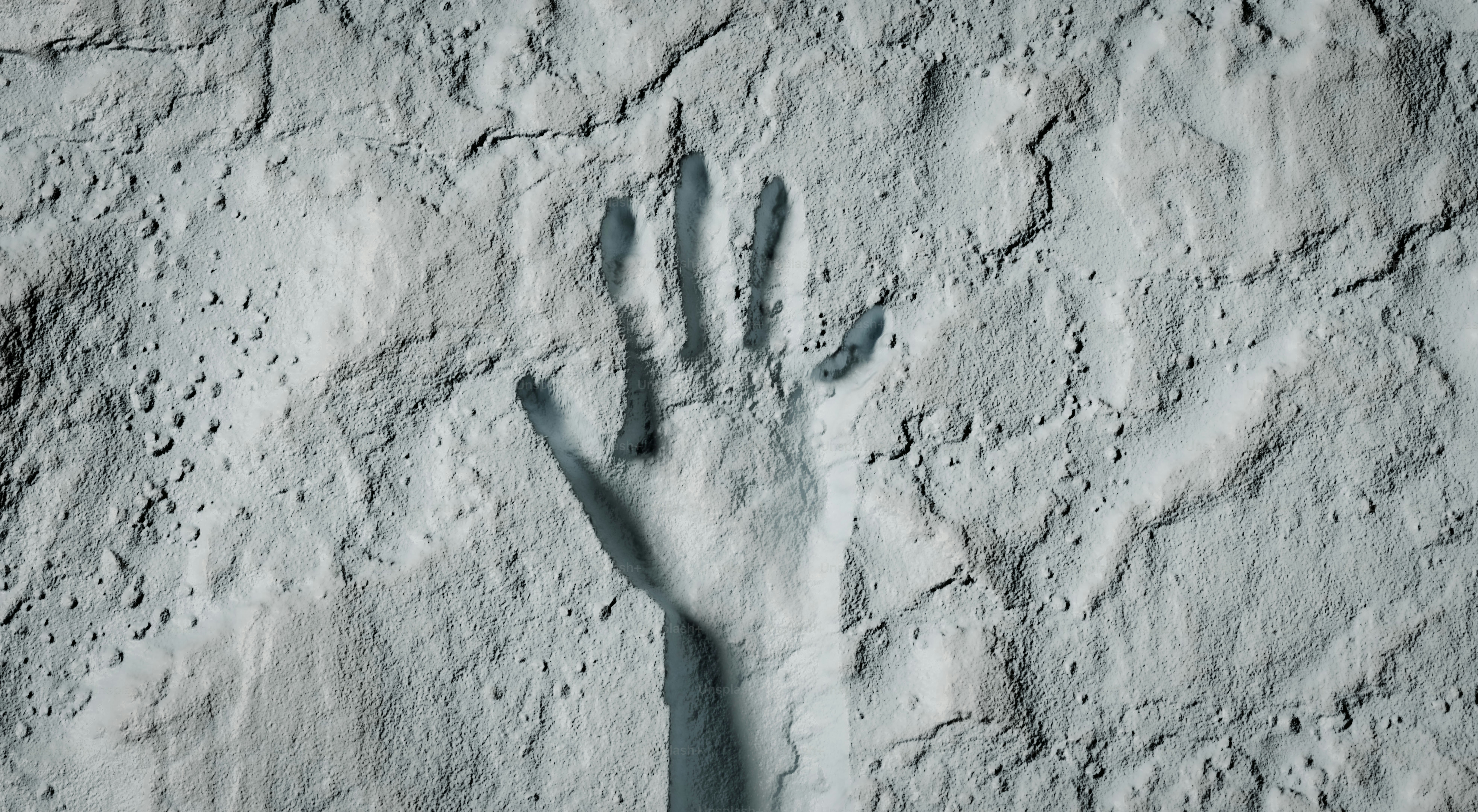 Handprint pressed into white textured surface