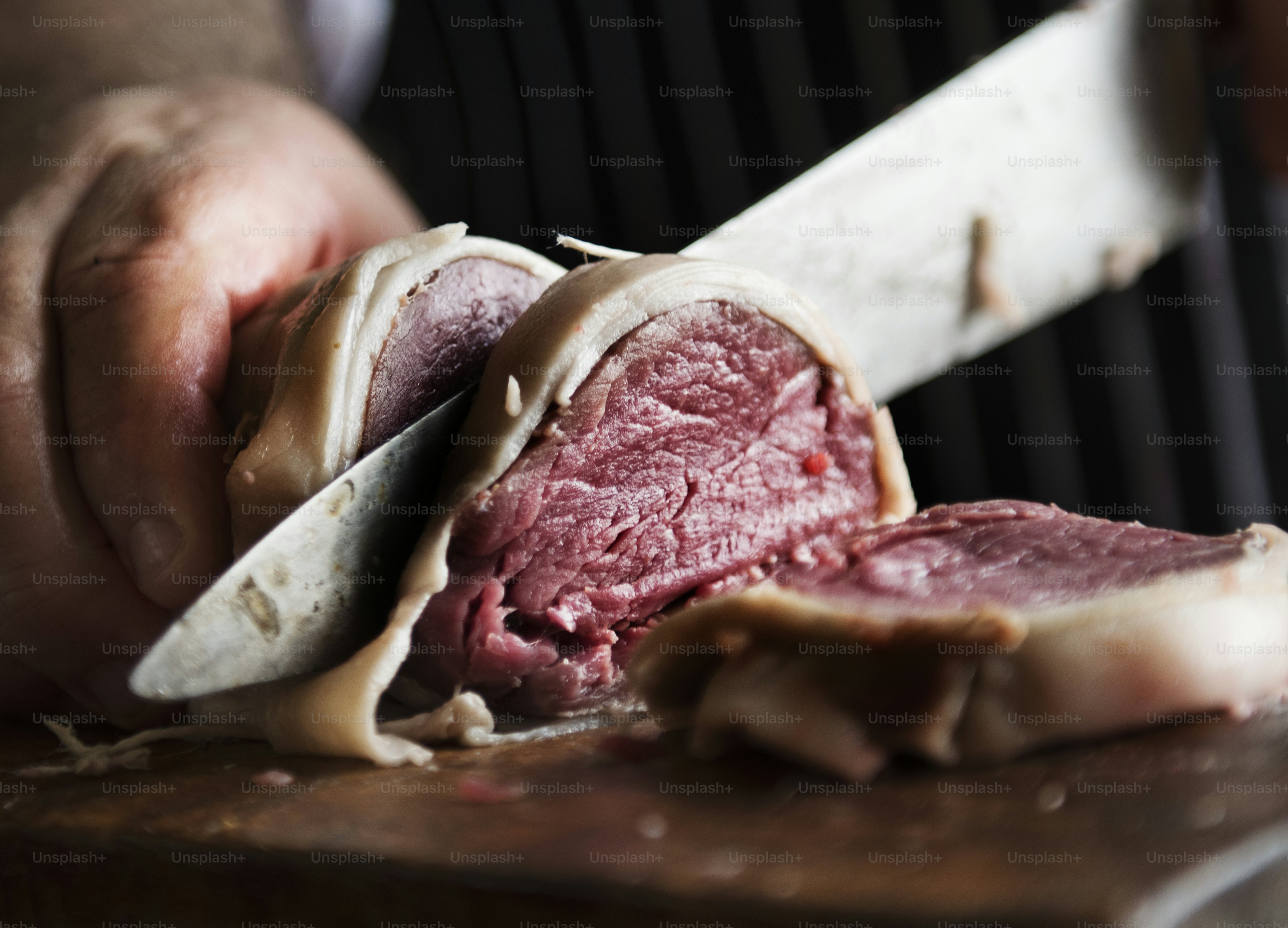 A chef working on slicing a piece of steak food photography recipe idea