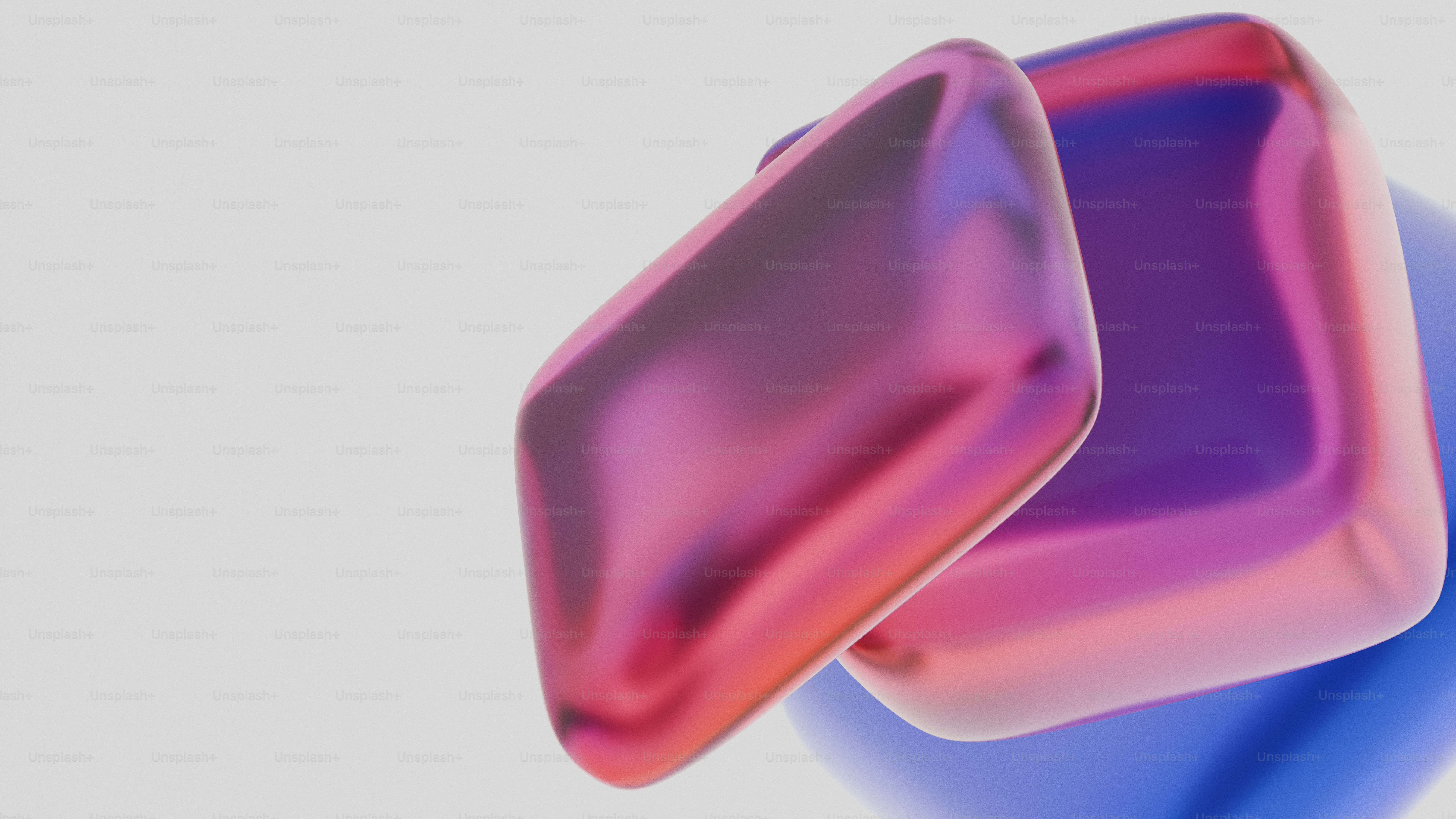 Two metallic cubes with pink and blue reflections