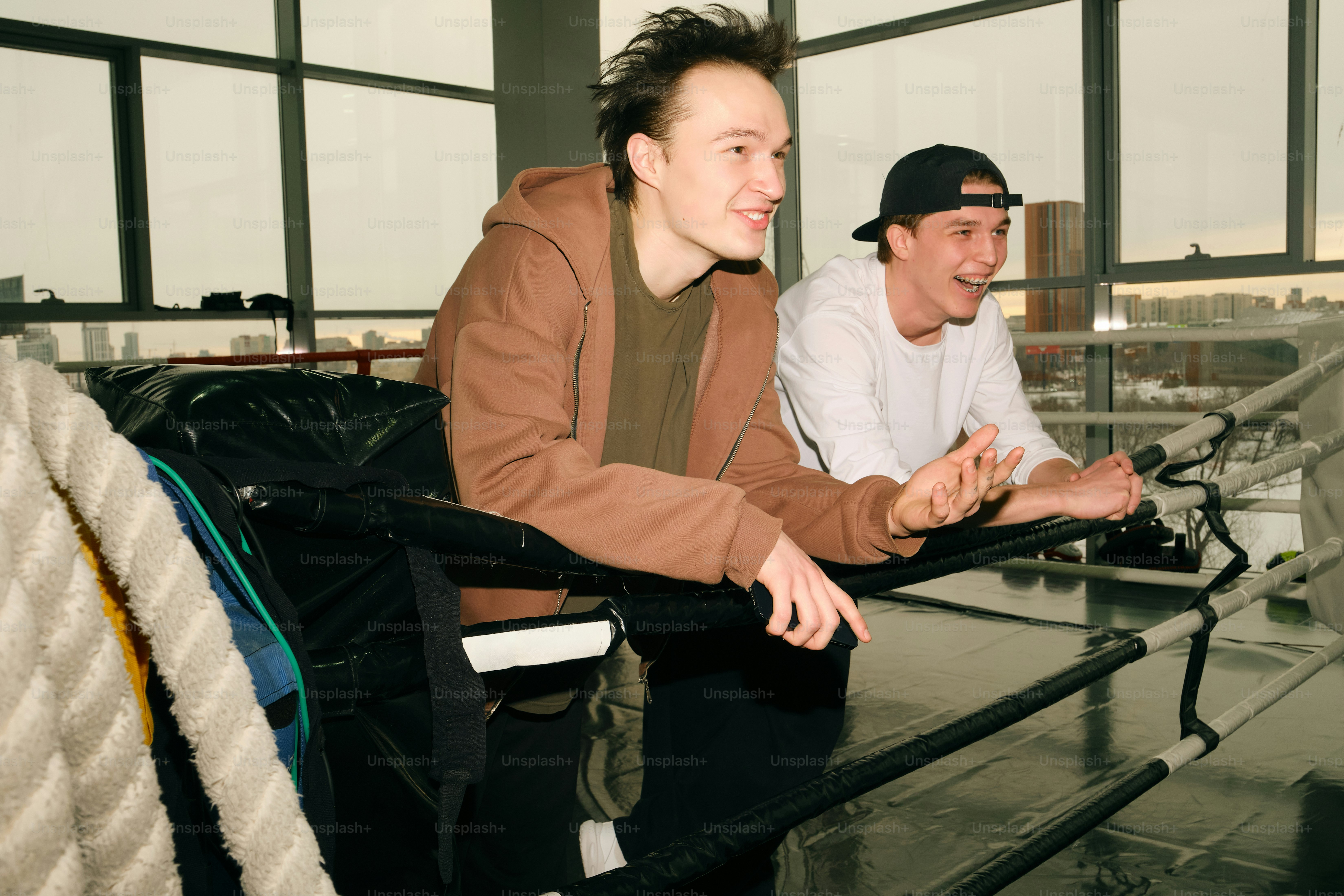 Two young men looking out a window