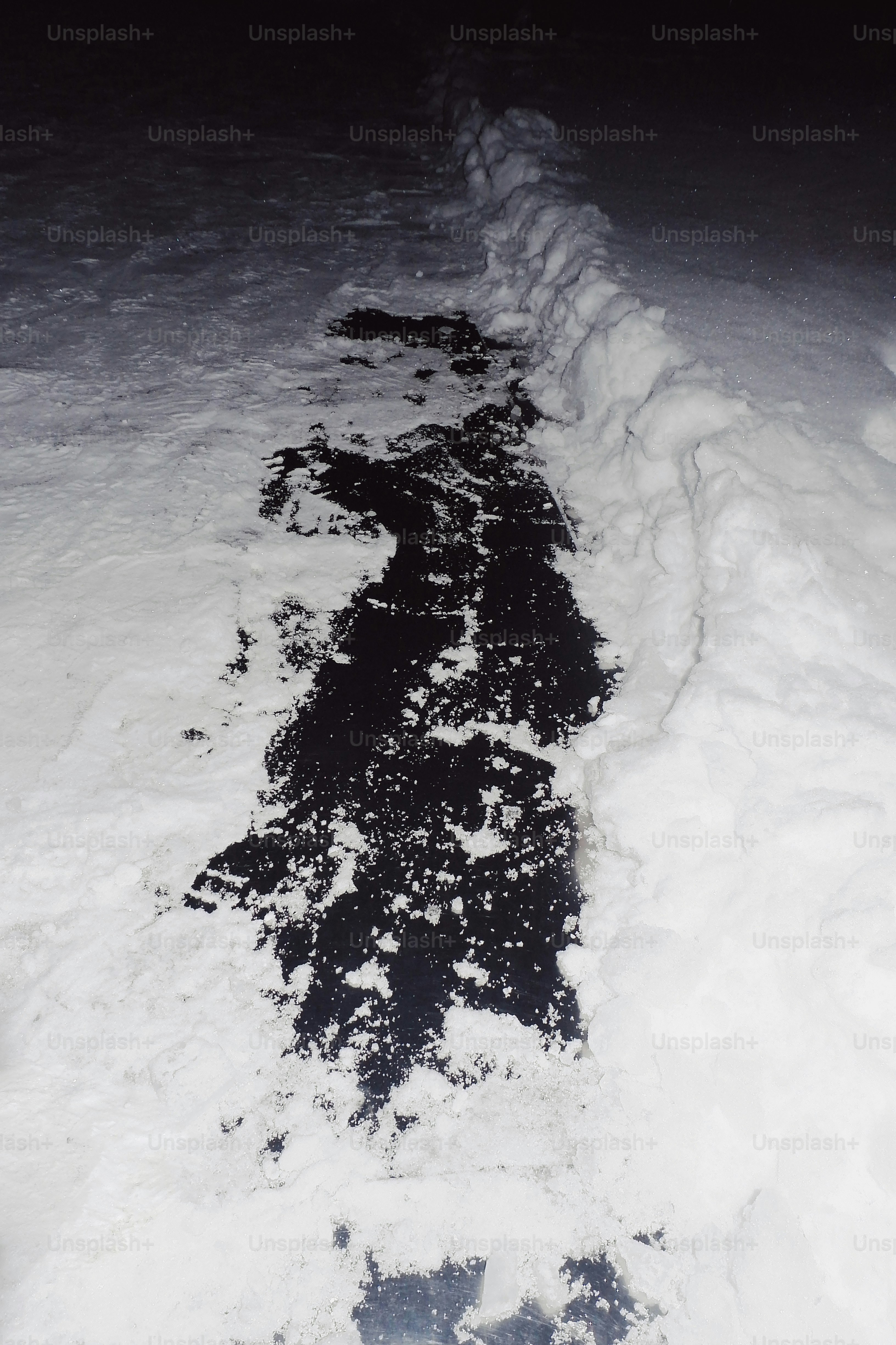 A path cleared through snow at night photo – Outdoor Image on Unsplash