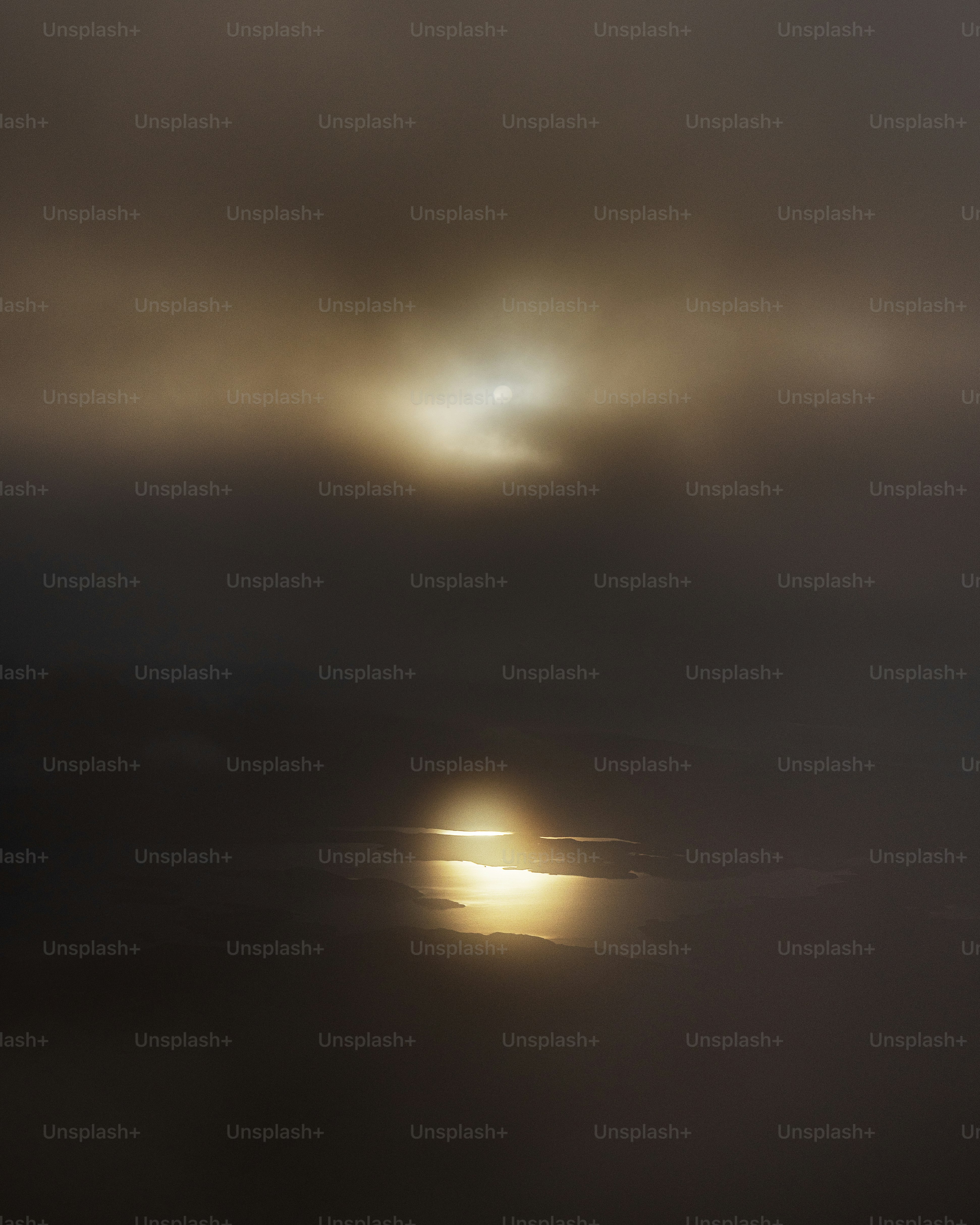 Sun obscured by fog reflecting on water