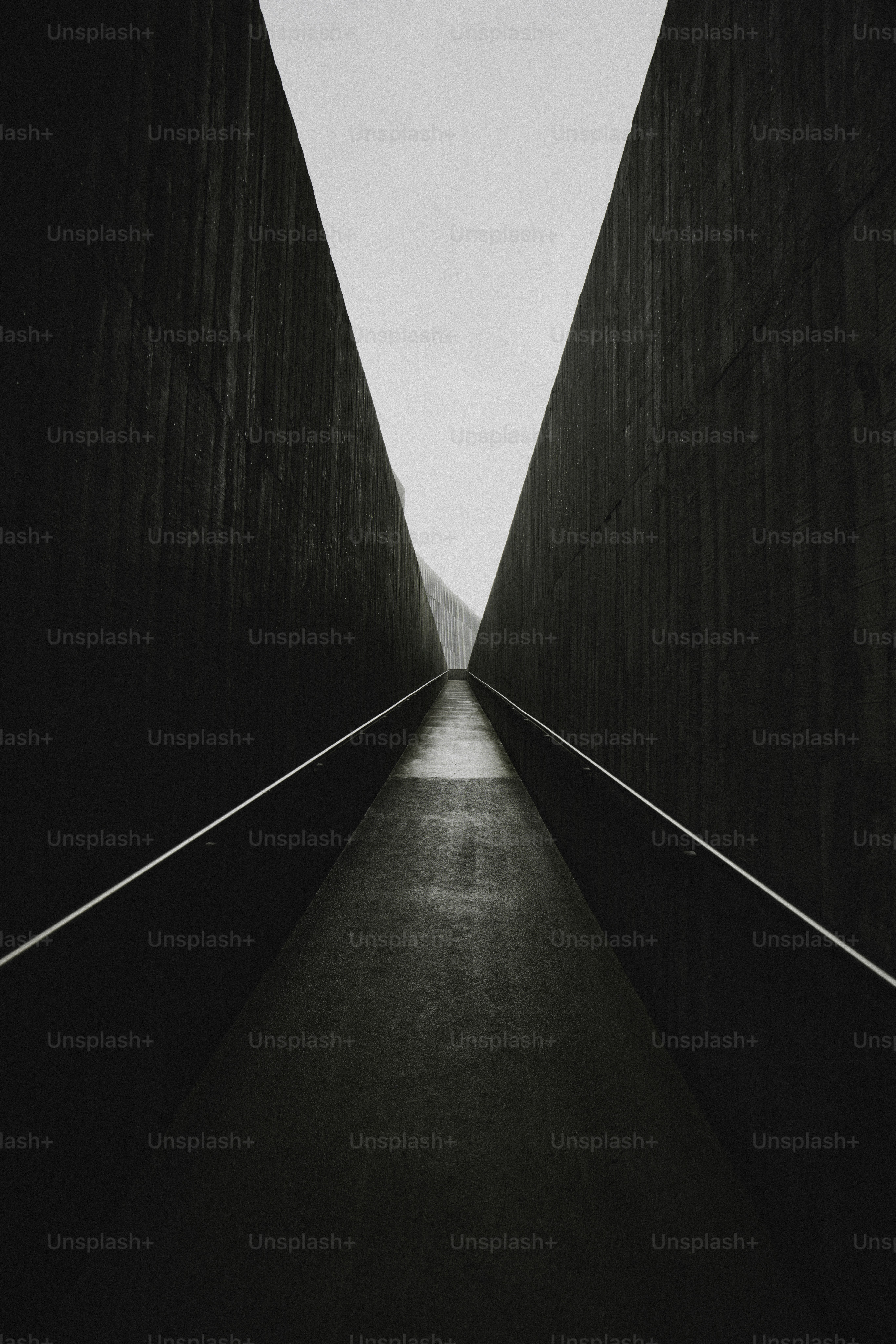 A dark, narrow pathway leading to a bright opening.
