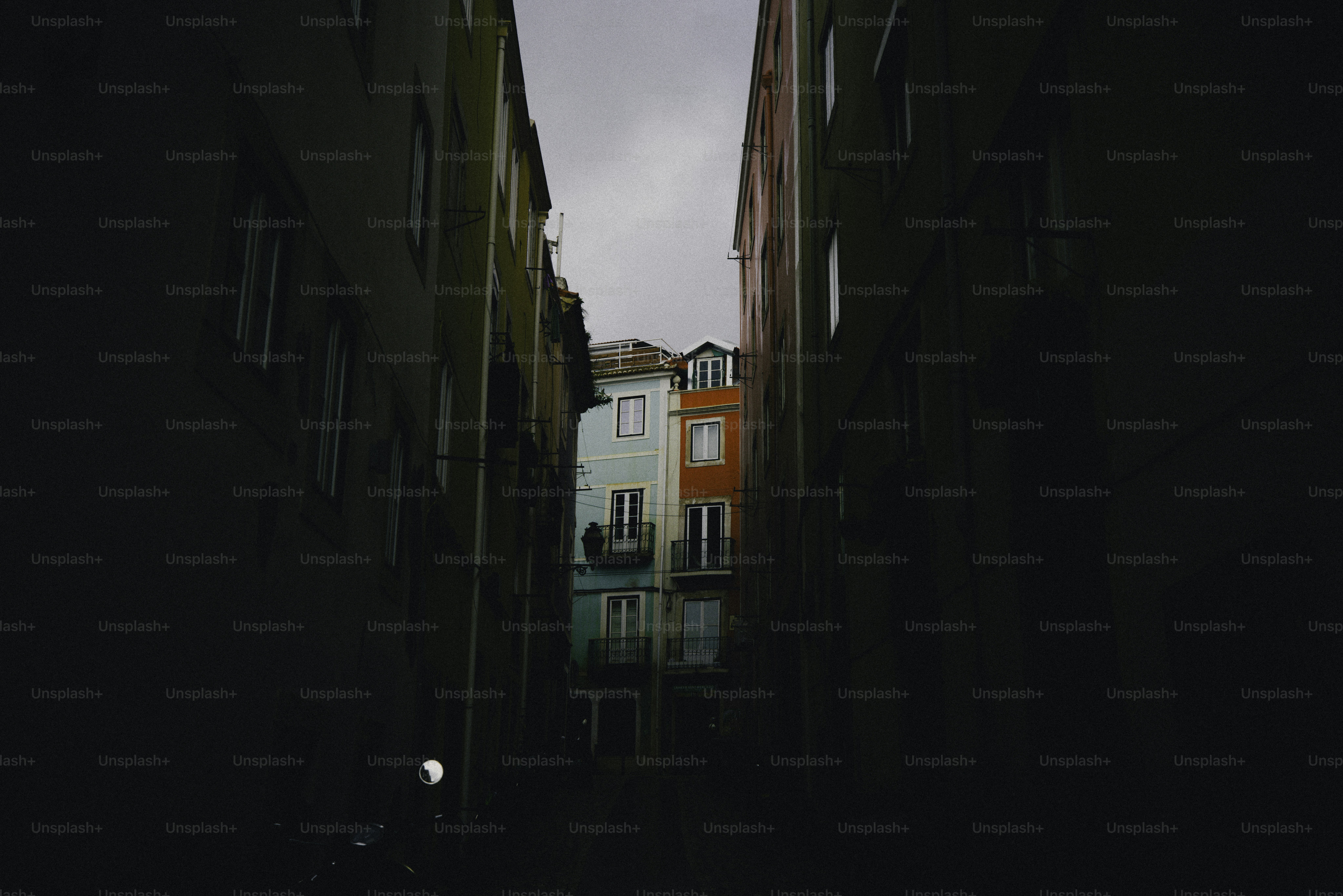Colorful buildings seen down a dark narrow alley.