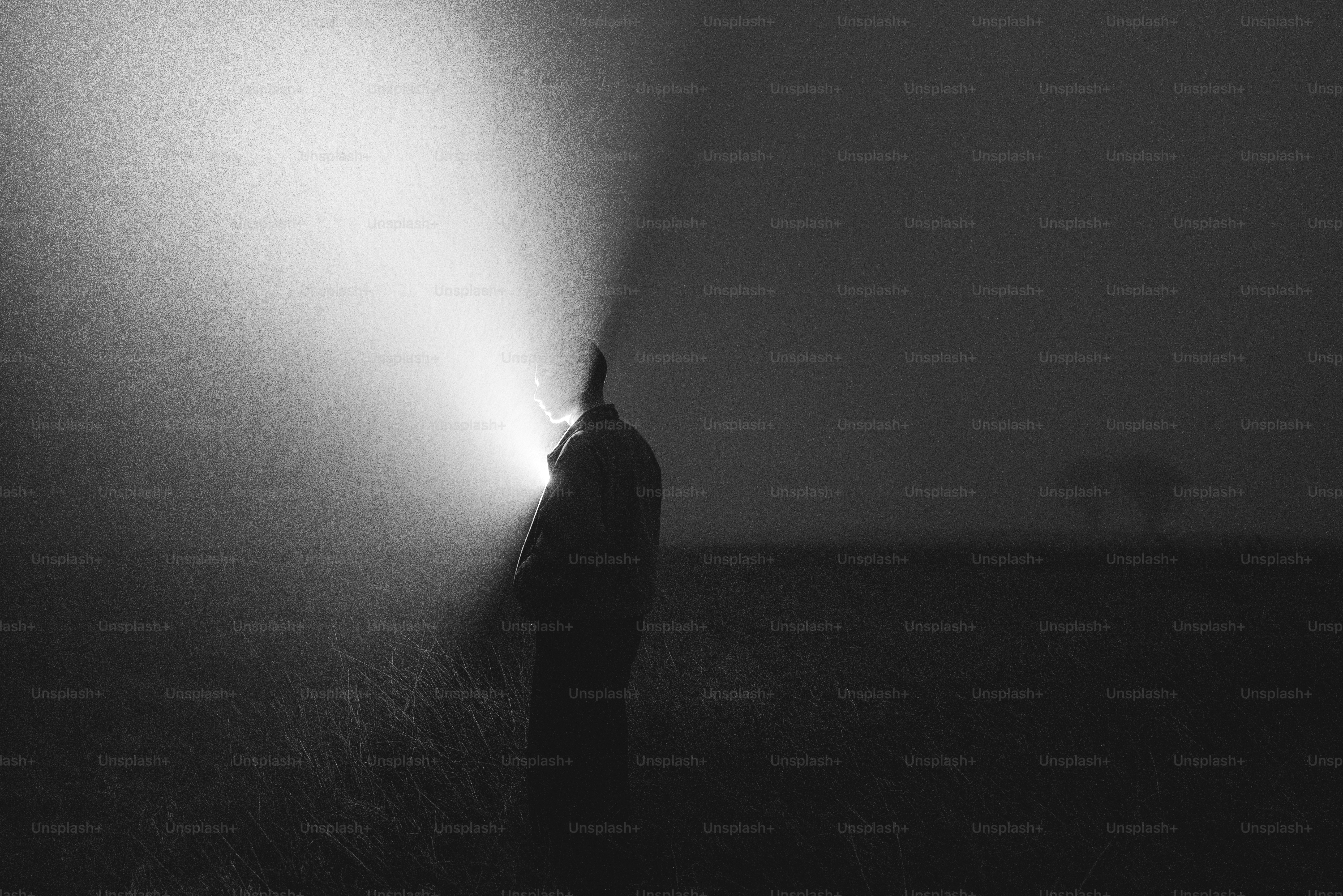 A lone figure illuminated by a bright light in darkness photo – Hope ...